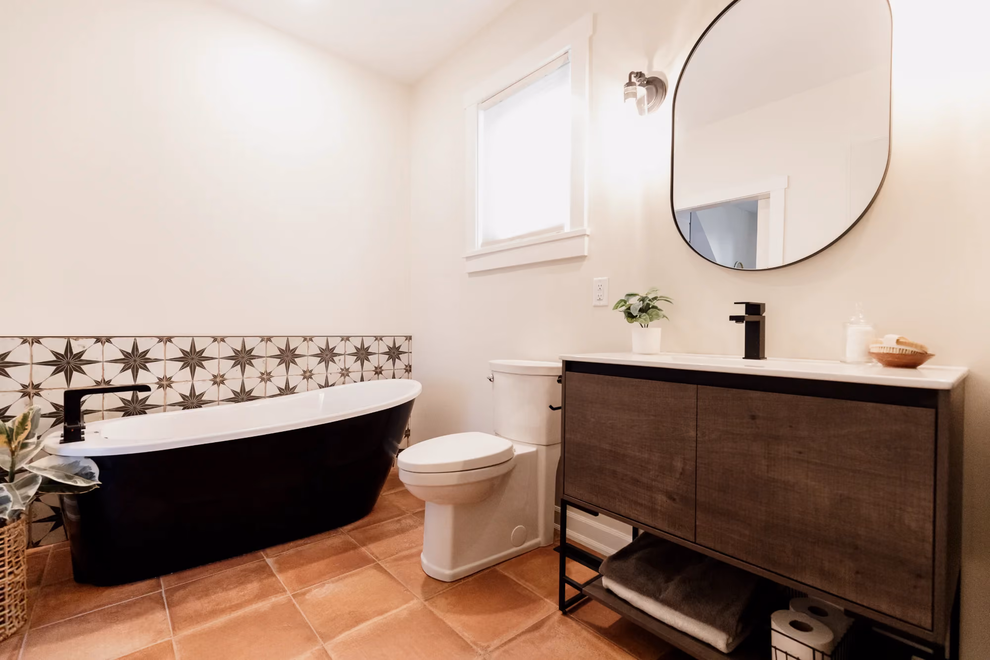 Bathroom with bathtub and wood vanity