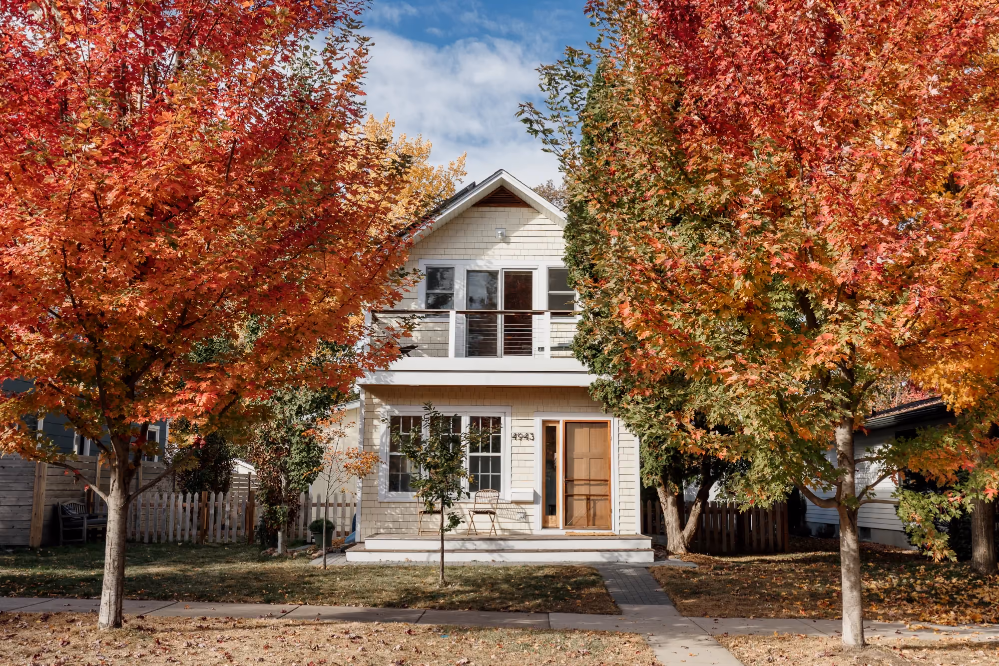 House exterior with autumn trees in front