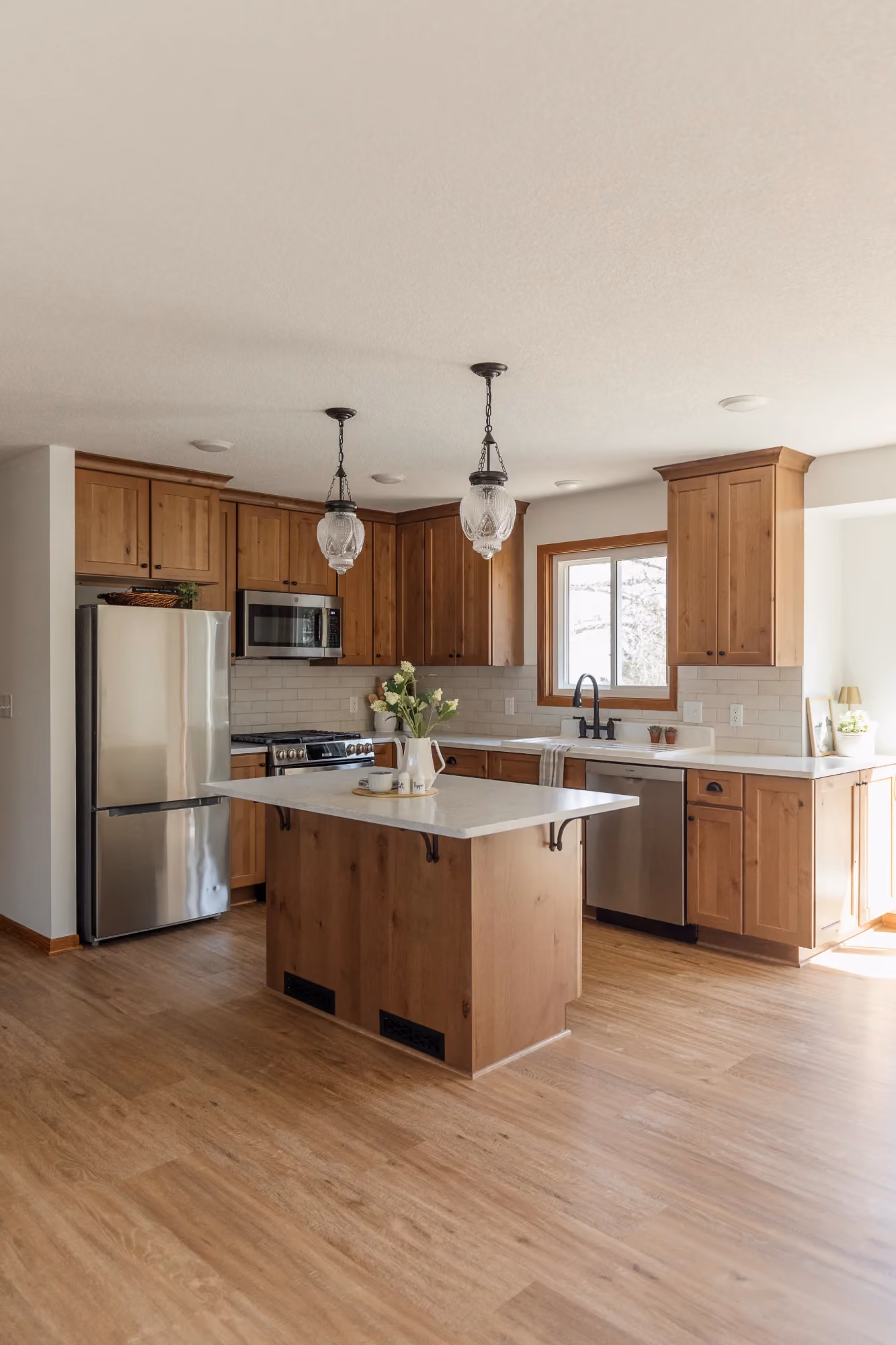 Kitchen and dining area with wood cabinets and island