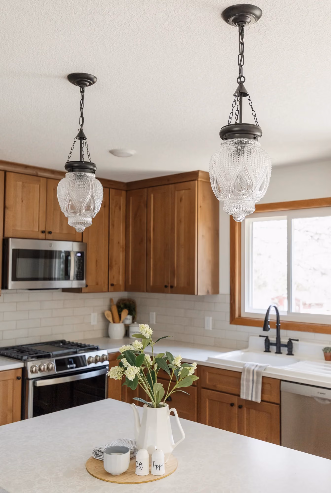 Modern kitchen with wood cabinets and pendant lights