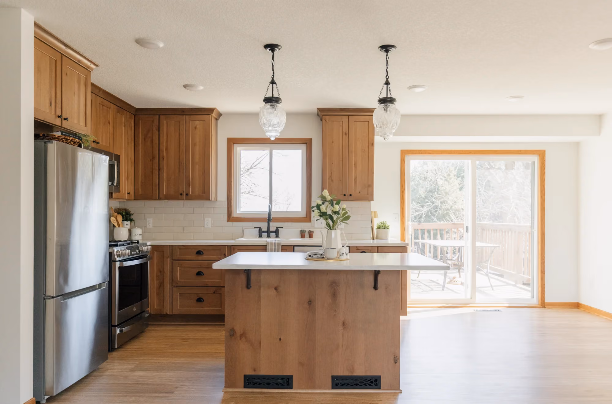 Bright kitchen with island and sliding glass door - 2