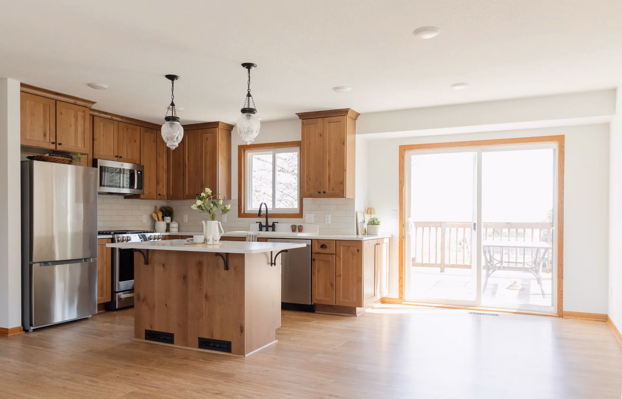 Bright kitchen with island and sliding glass door