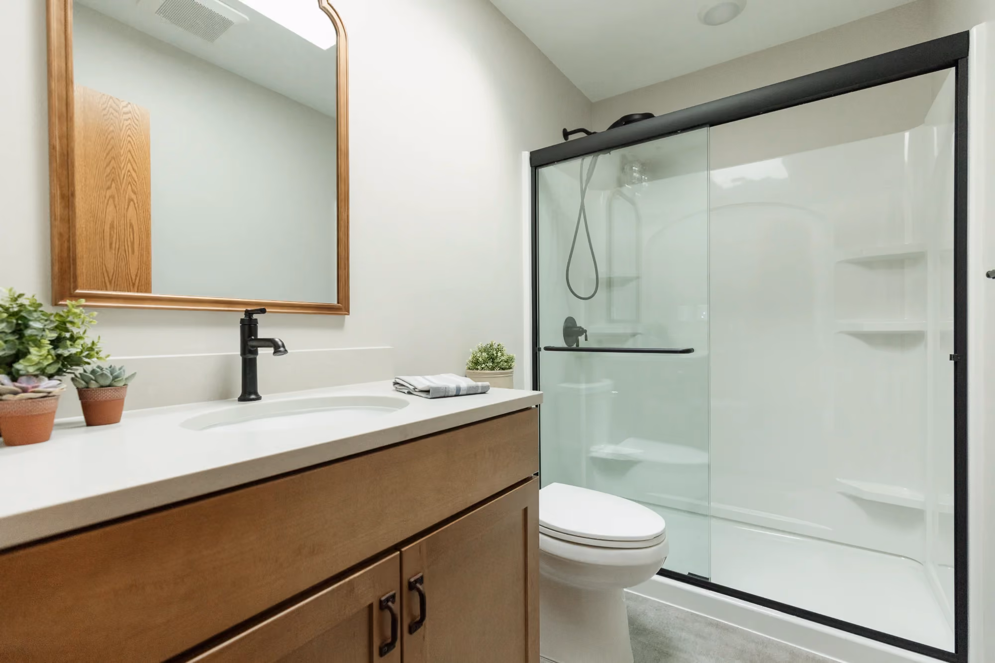 Modern bathroom vanity with glass shower enclosure