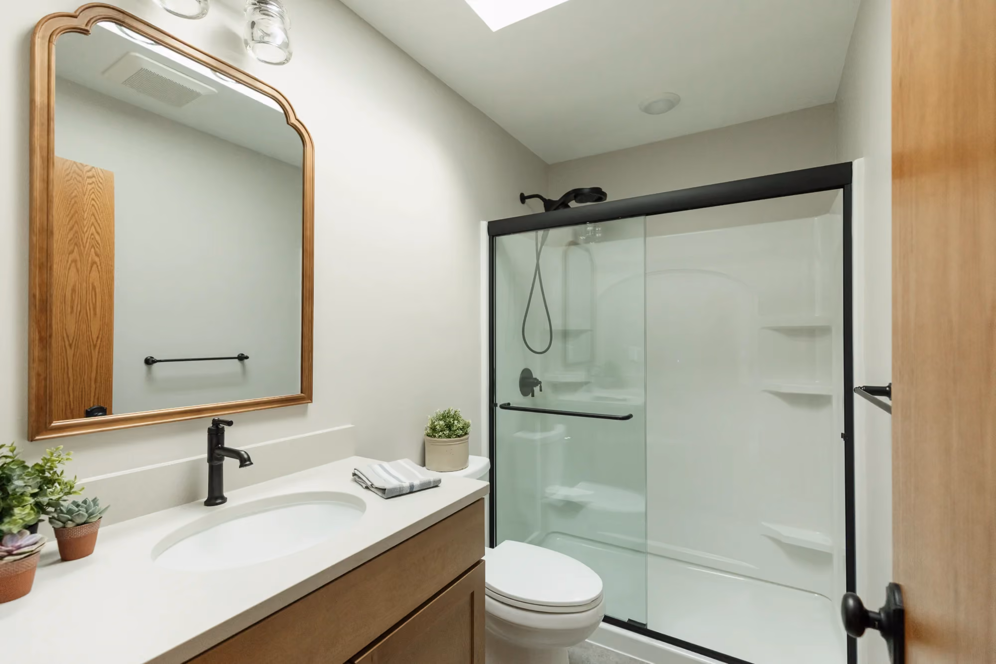Bathroom vanity with mirror and glass shower