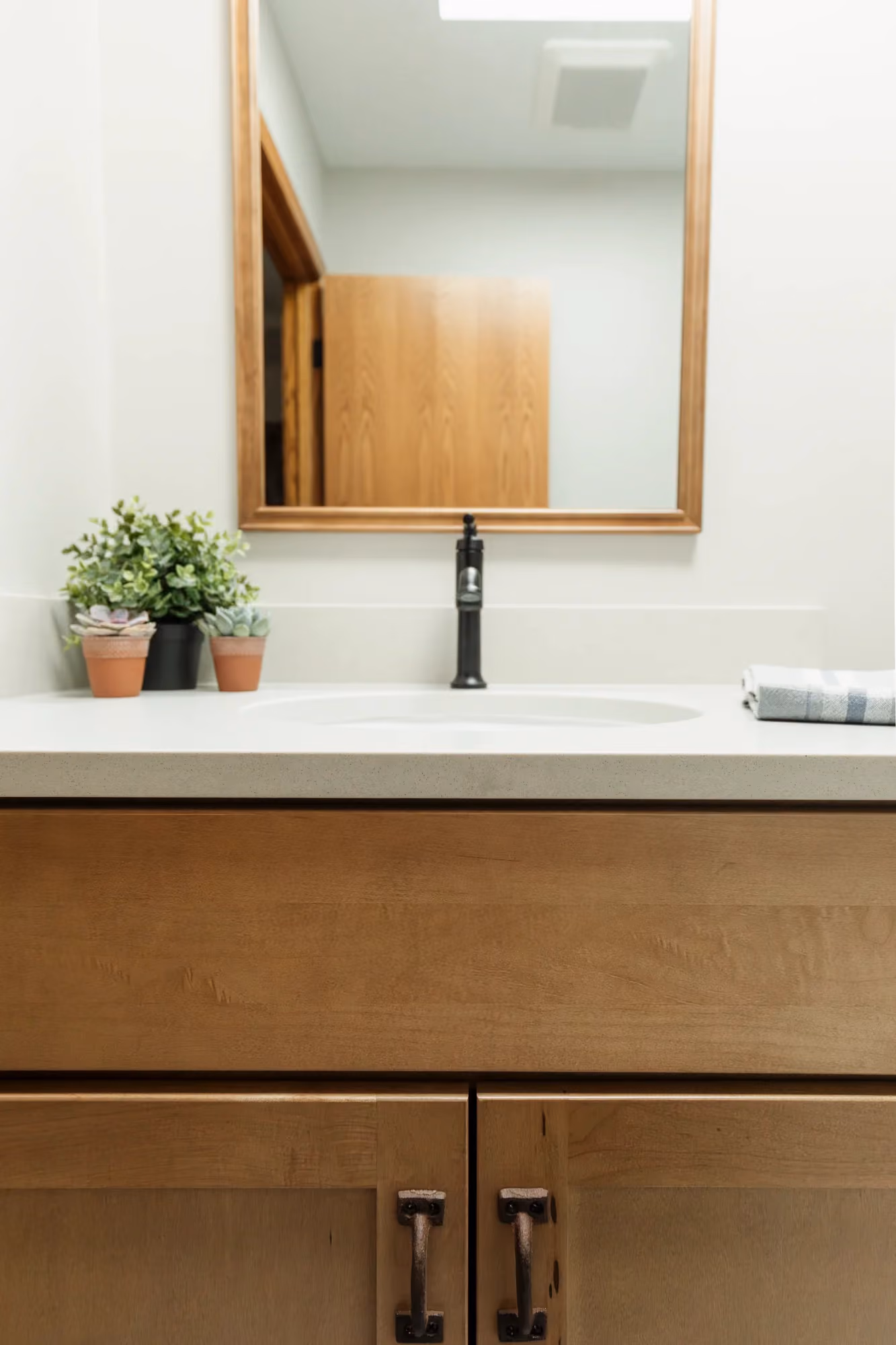 Bathroom vanity with mirror and wood cabinetry