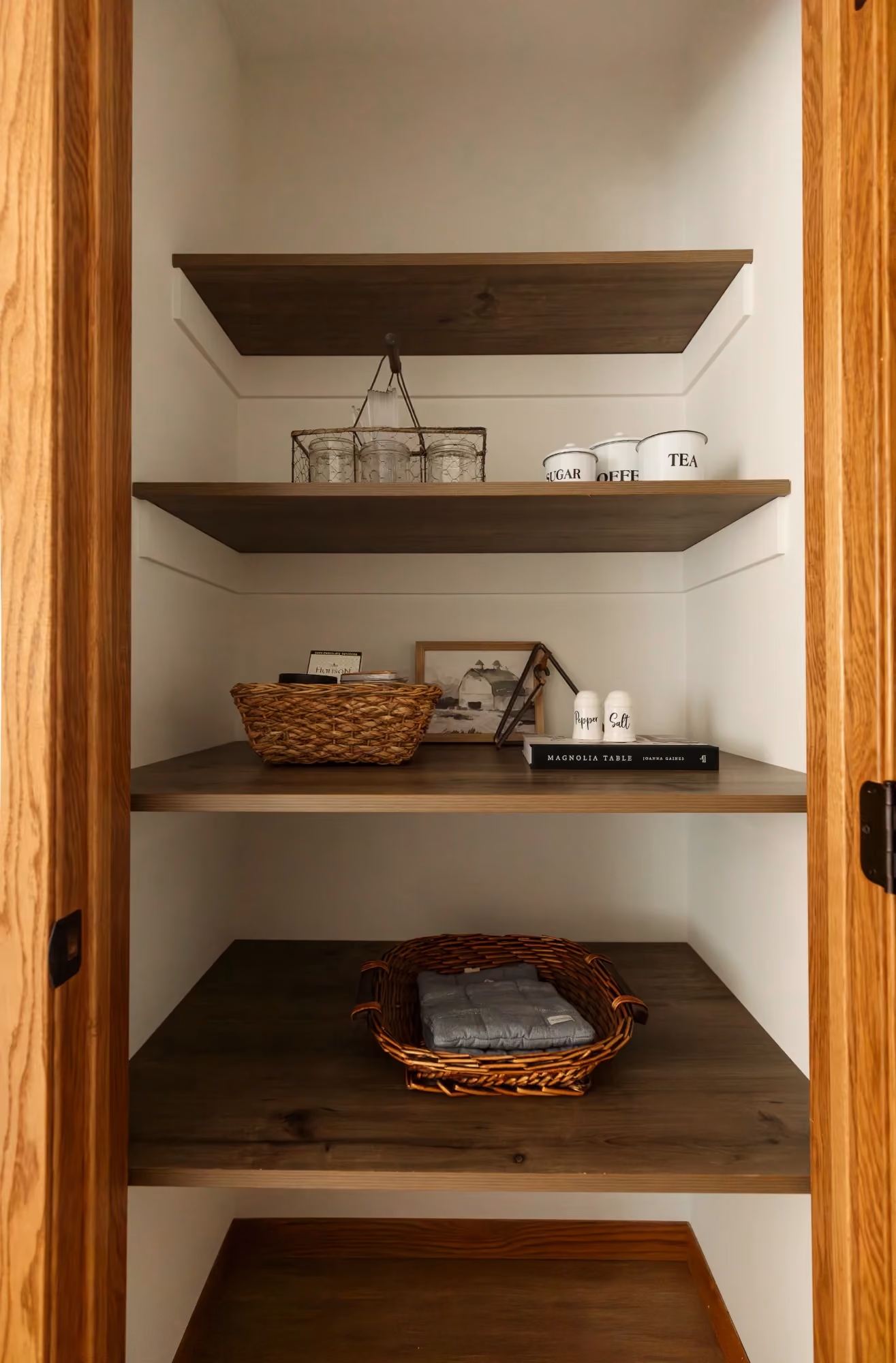 Wooden pantry nook with open shelves and a small counter