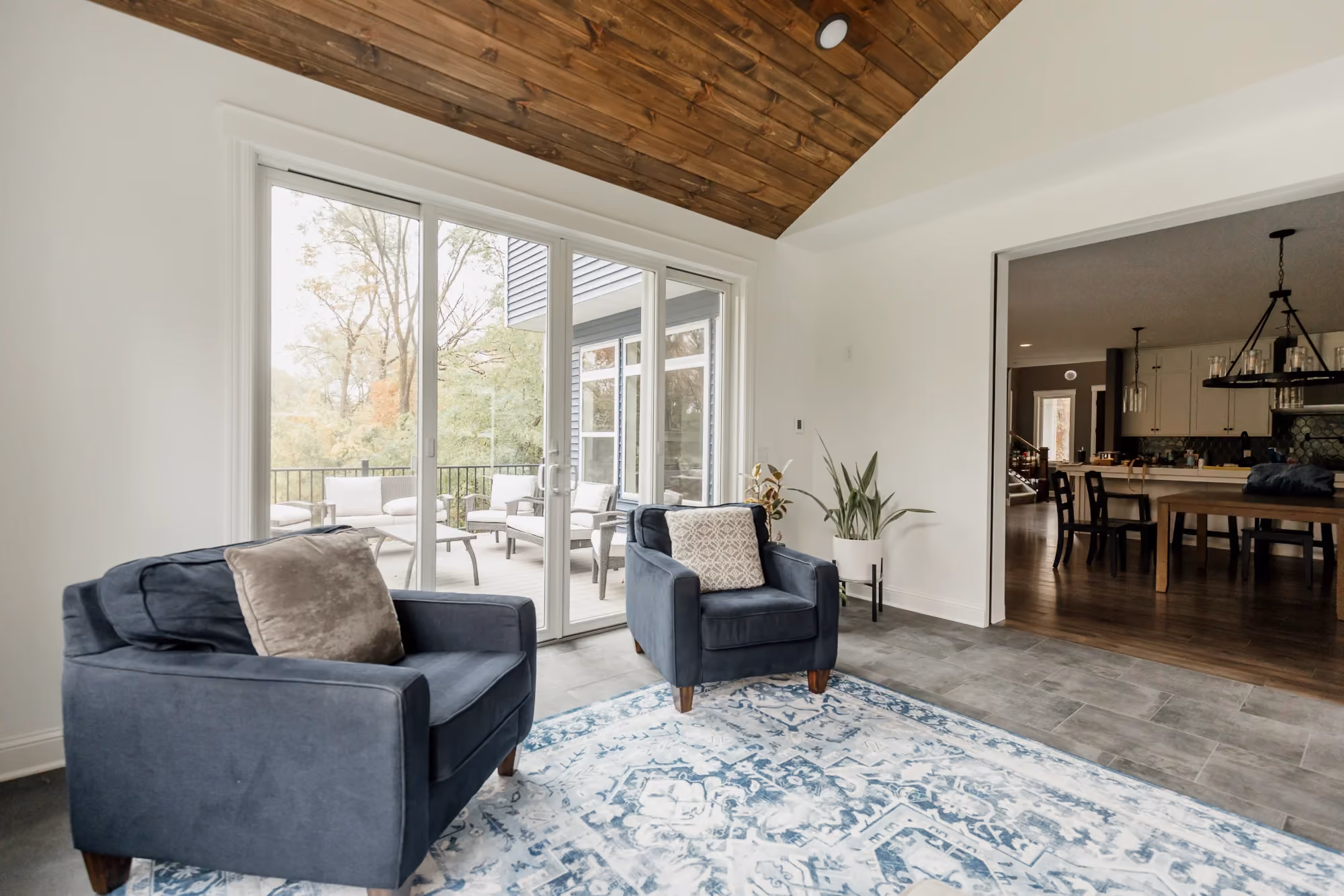 Bright living room with large windows and dining area