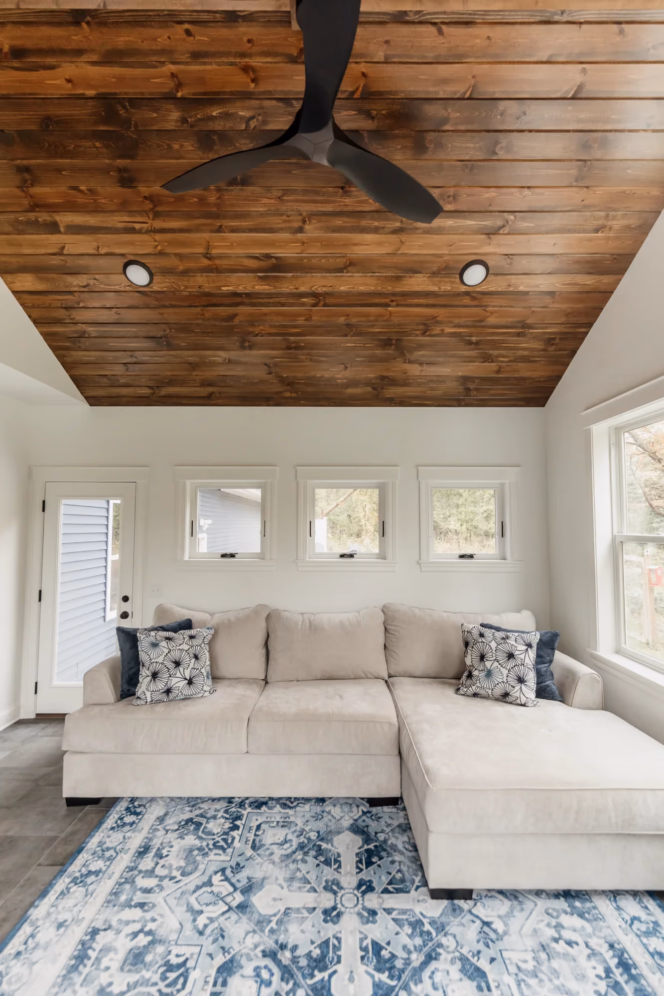 Bedroom with vaulted wood ceiling and large bed