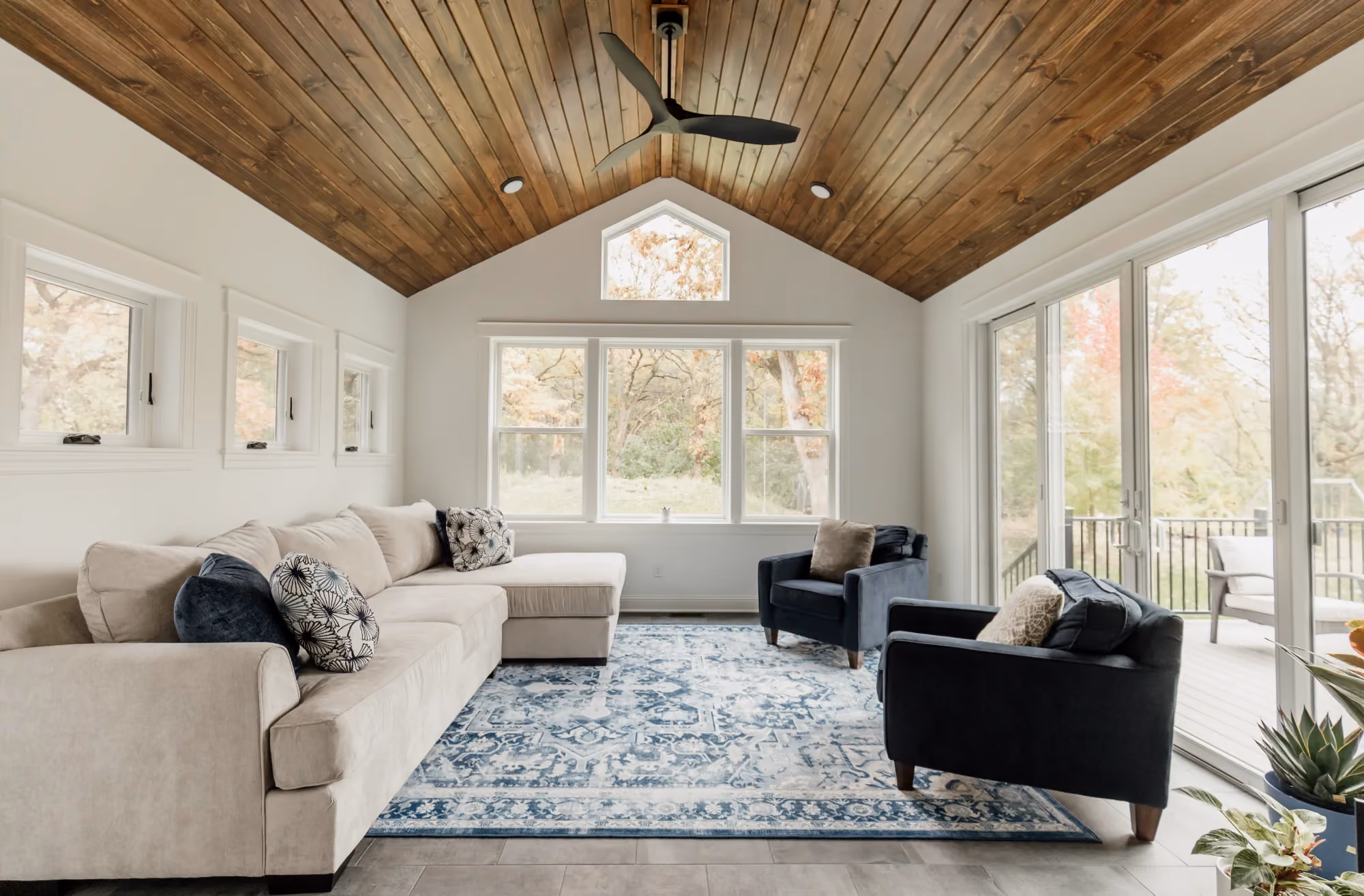 Spacious living room with vaulted wood ceiling and rug