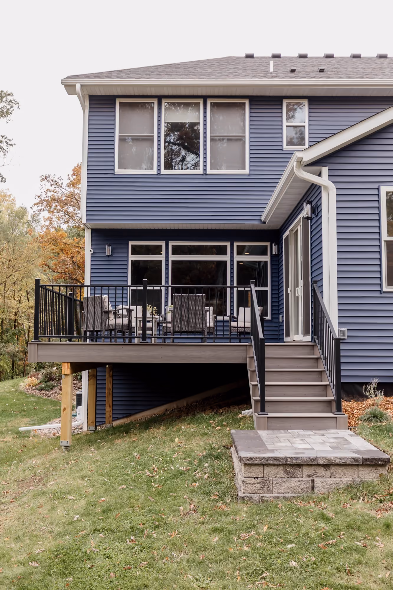 Rear view of two-story house with deck