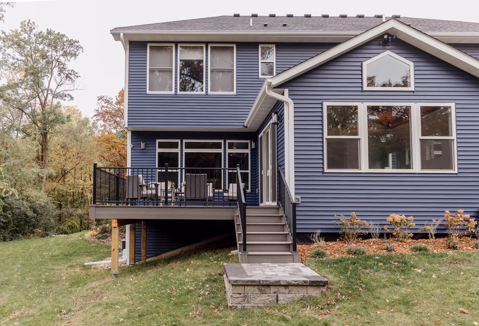 Exterior of blue house with deck and stairs