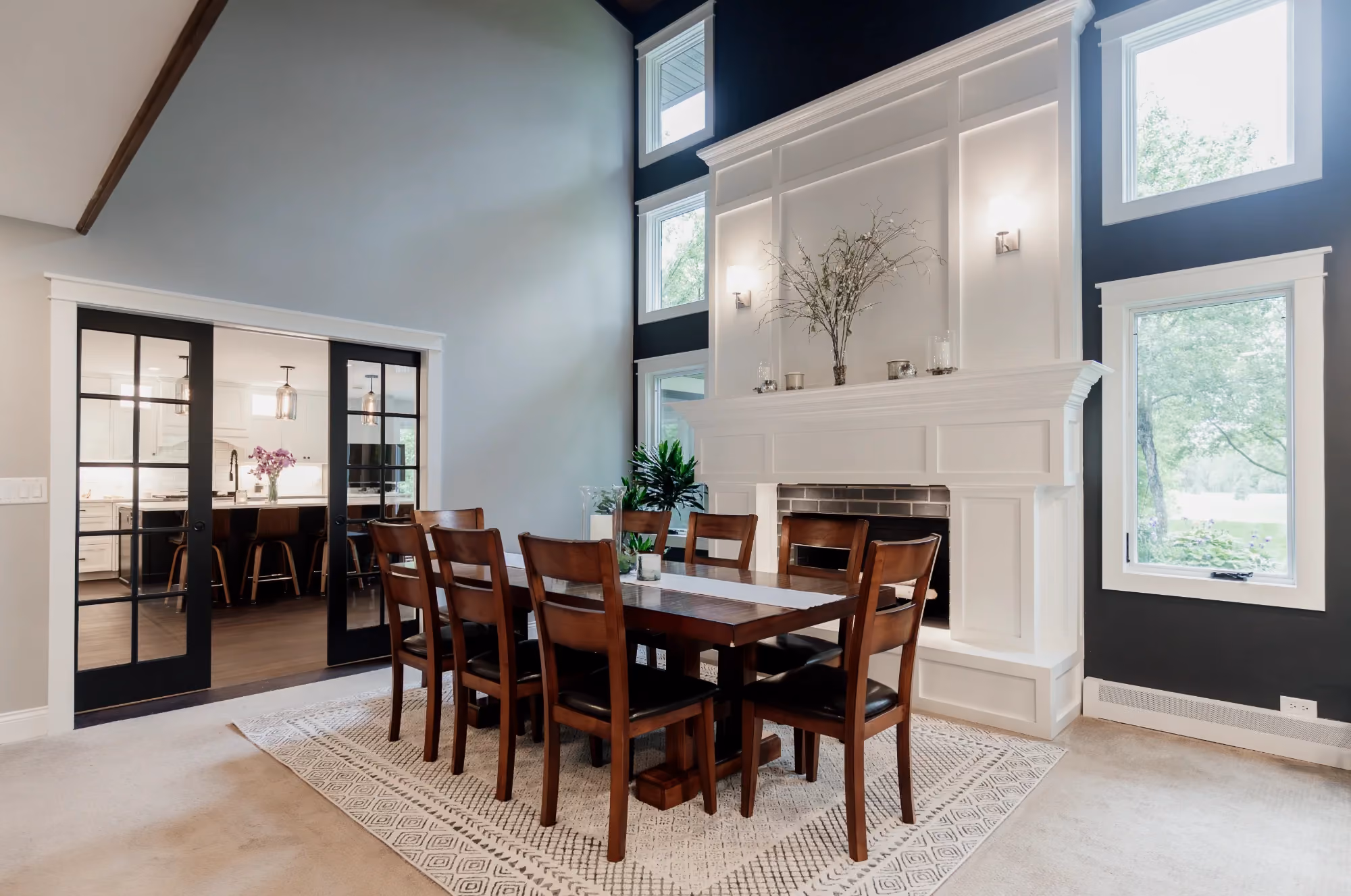 Double-height dining area with long wooden table