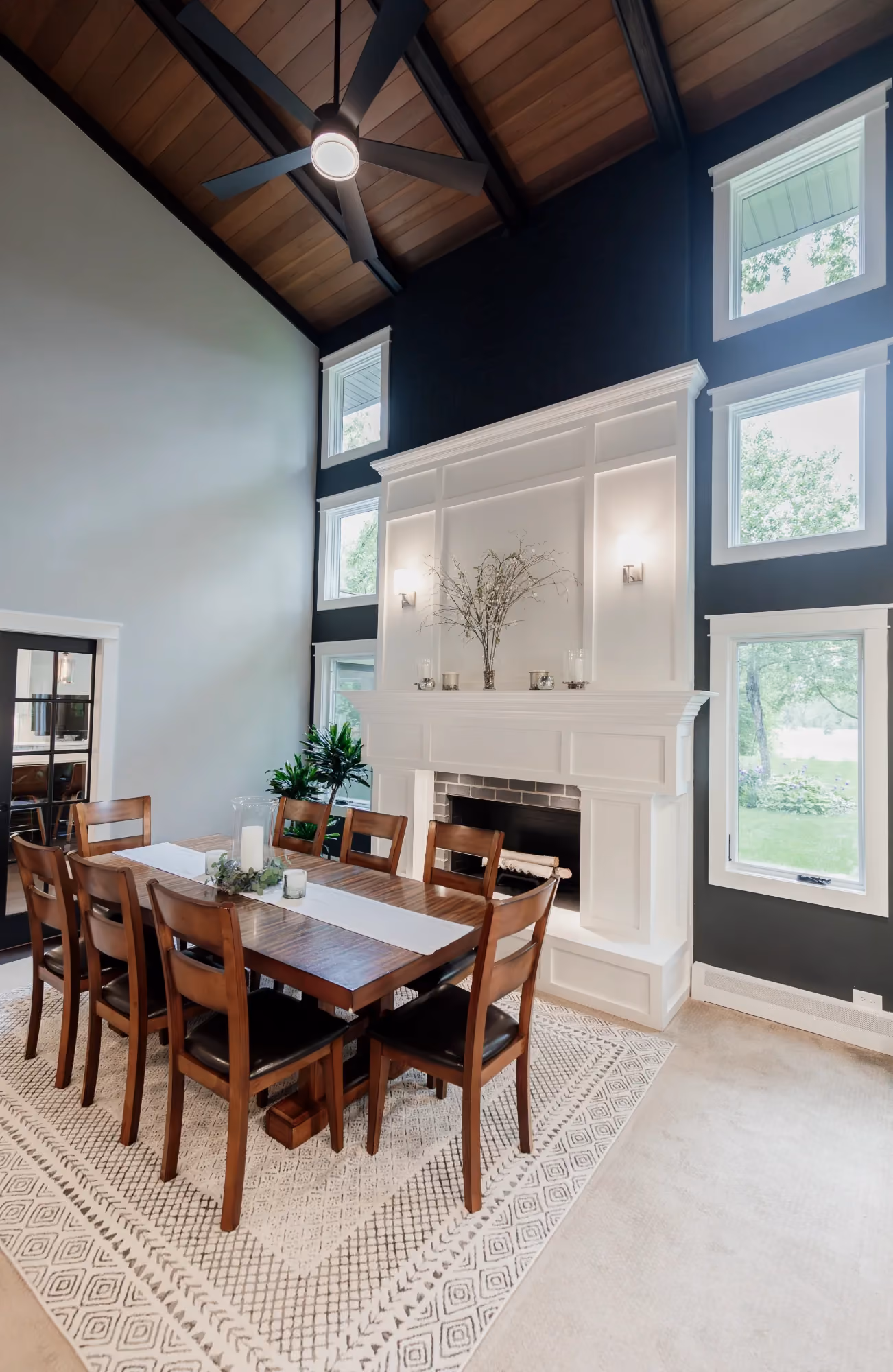 Dining area with high ceiling and large windows