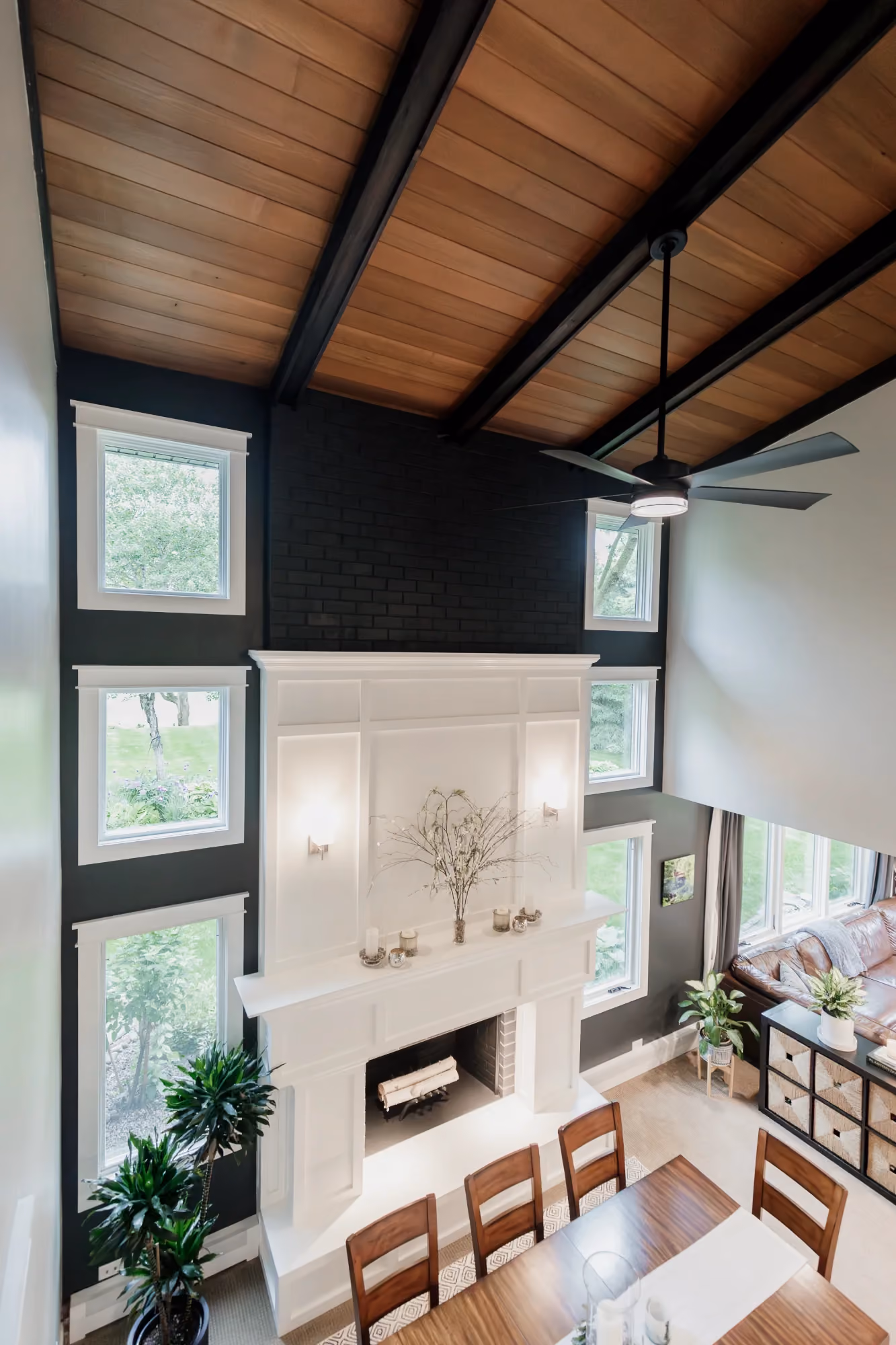 Vaulted ceiling living room with fireplace and large windows