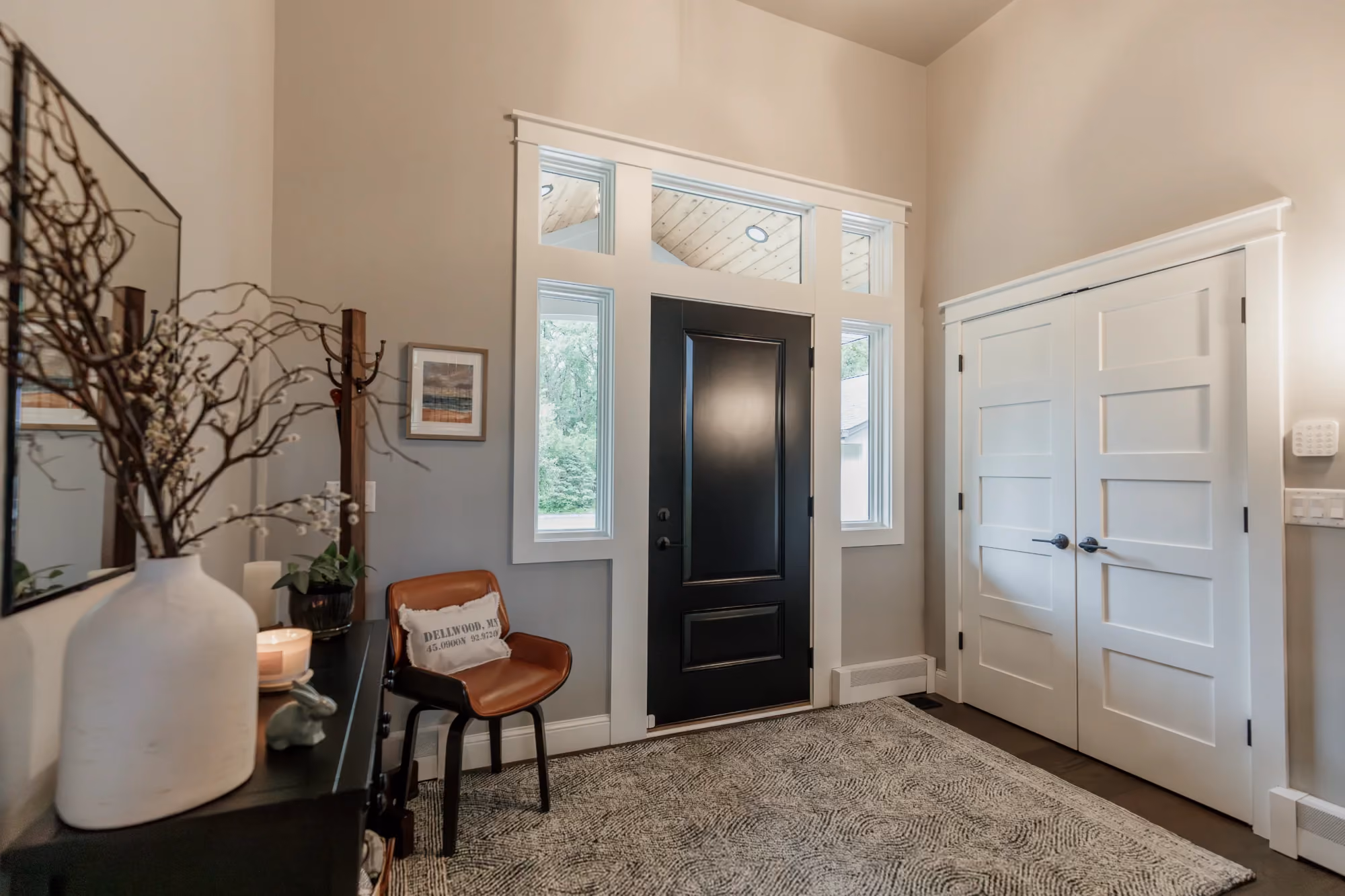 Front entryway with black door and tiled floor
