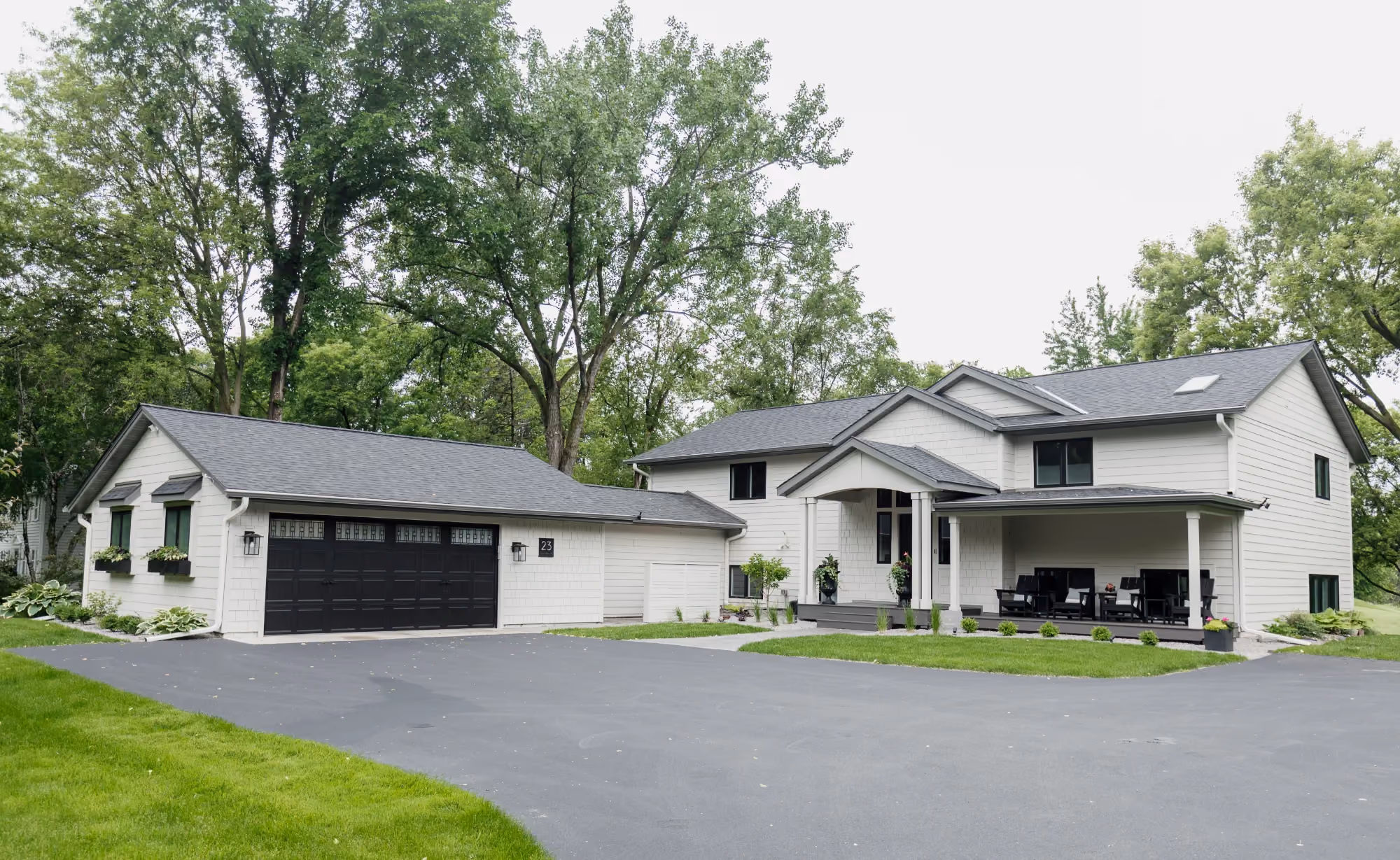 Modern white house with attached garage and driveway