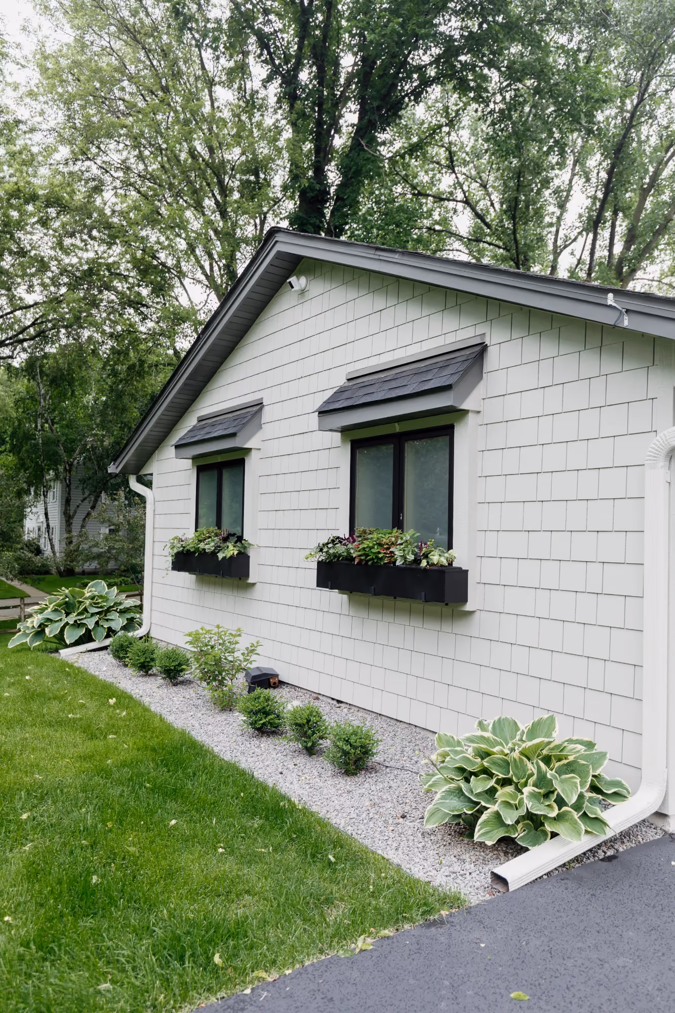 White cottage exterior with flower boxes and front walkway