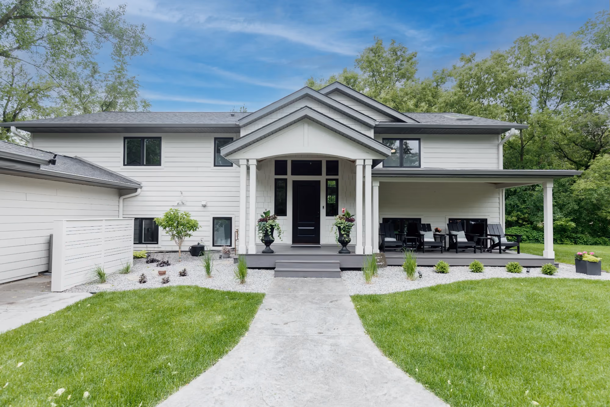 Symmetrical white home exterior with walkway to porch