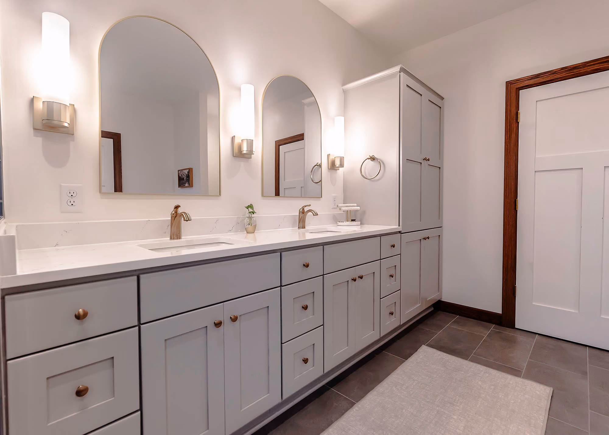 White double vanity bathroom with arched mirrors