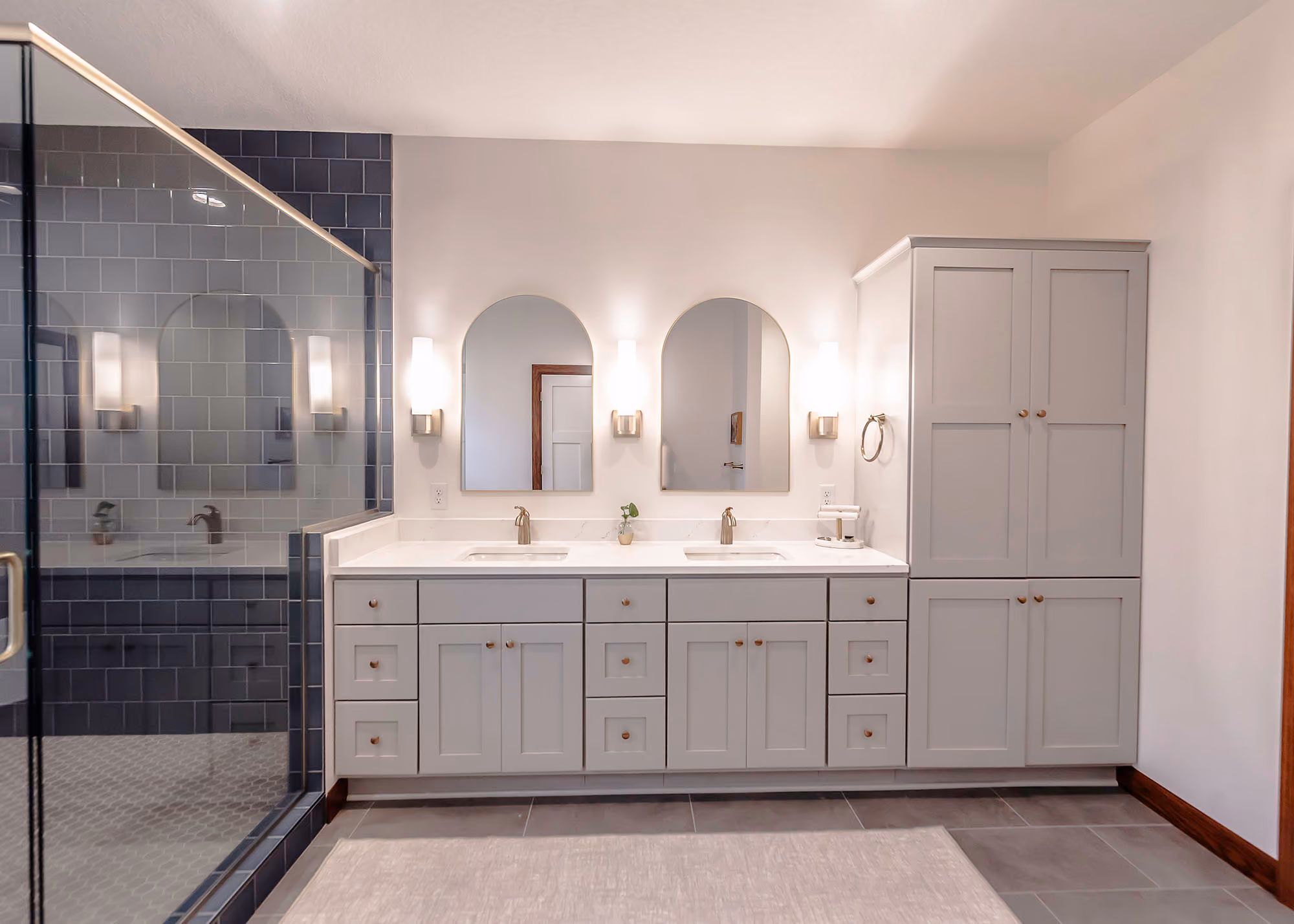 White double vanity bathroom with arched mirrors