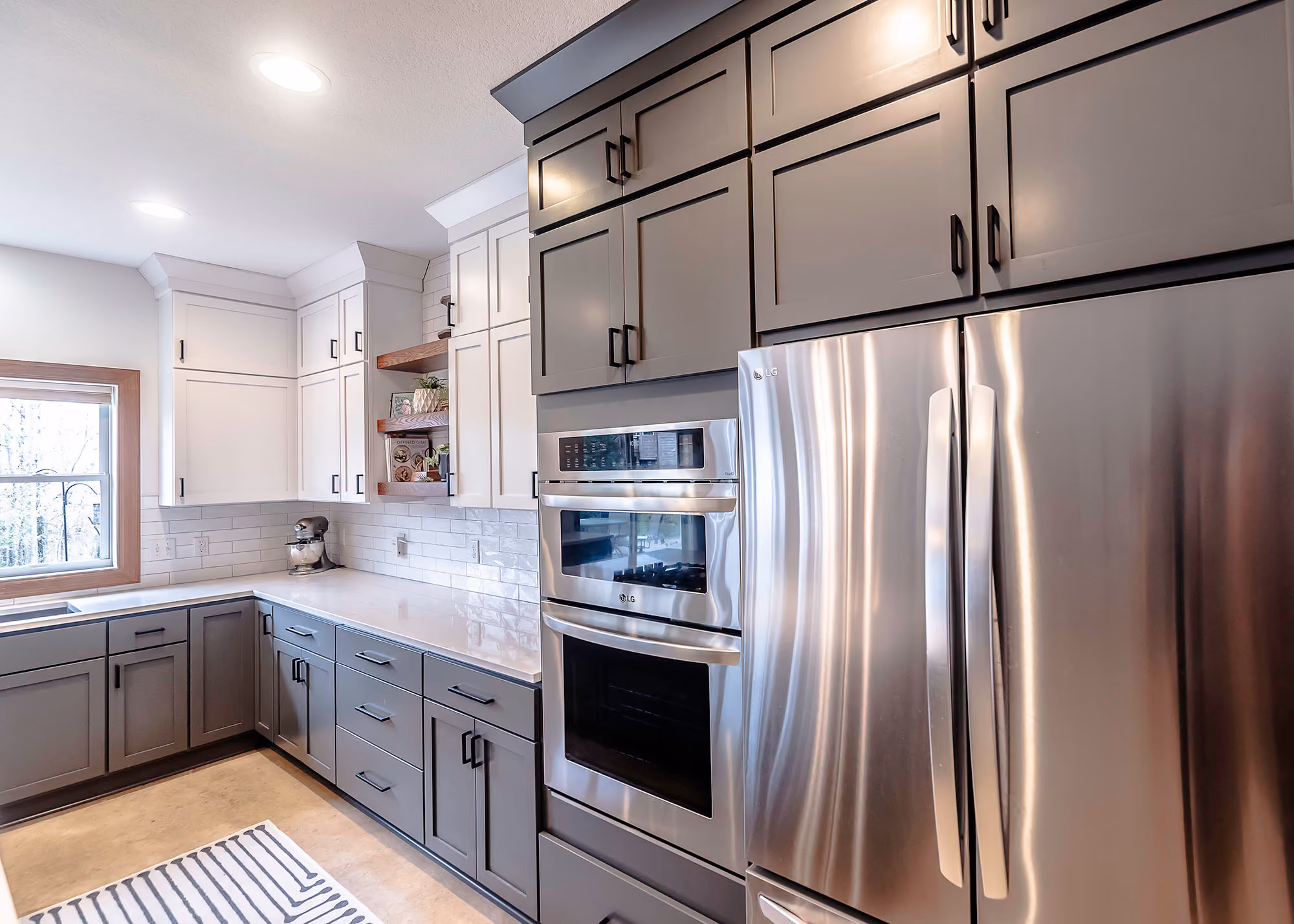 Kitchen with stainless steel fridge and built-in ovens