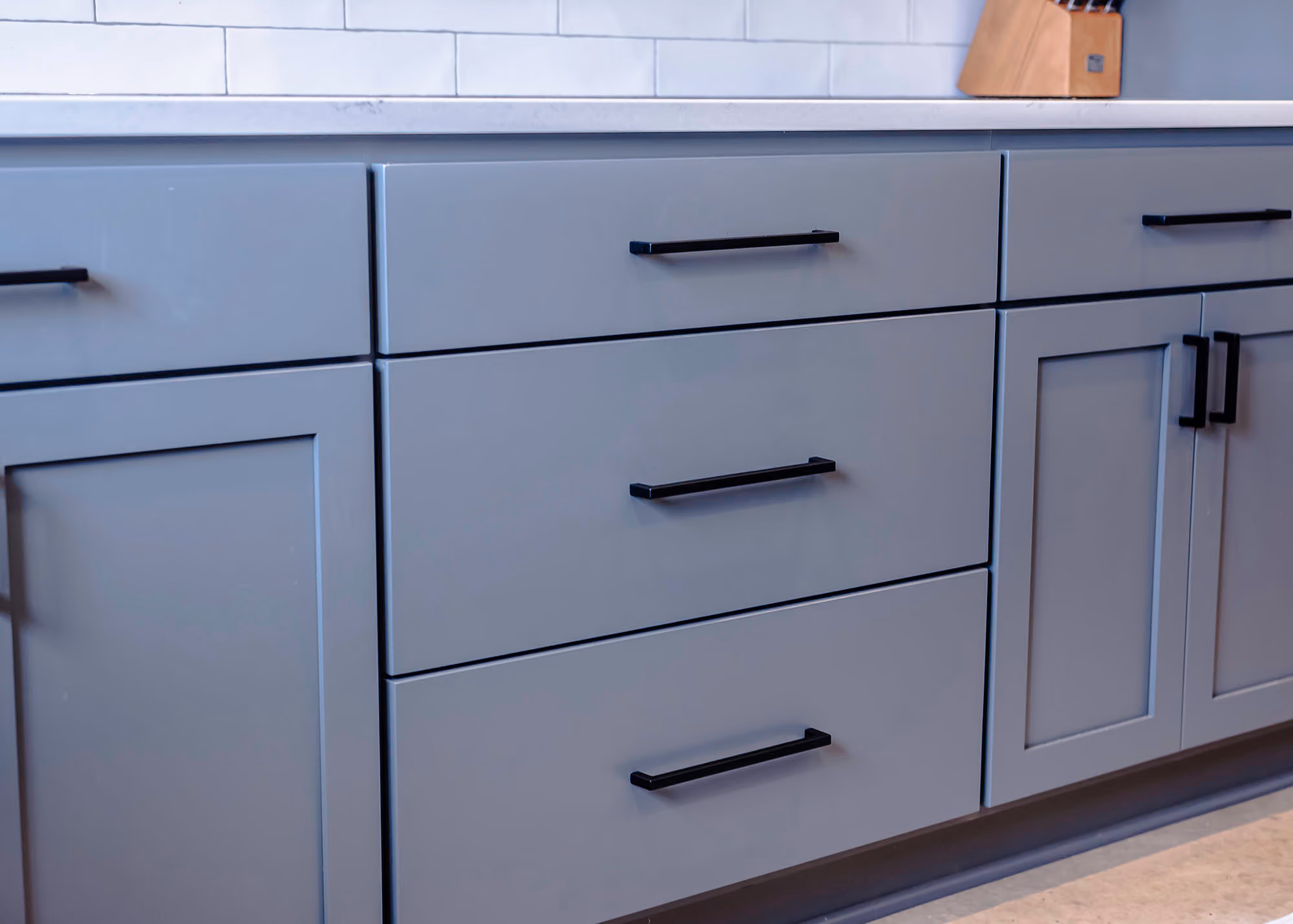 Close-up of gray kitchen cabinets and drawers