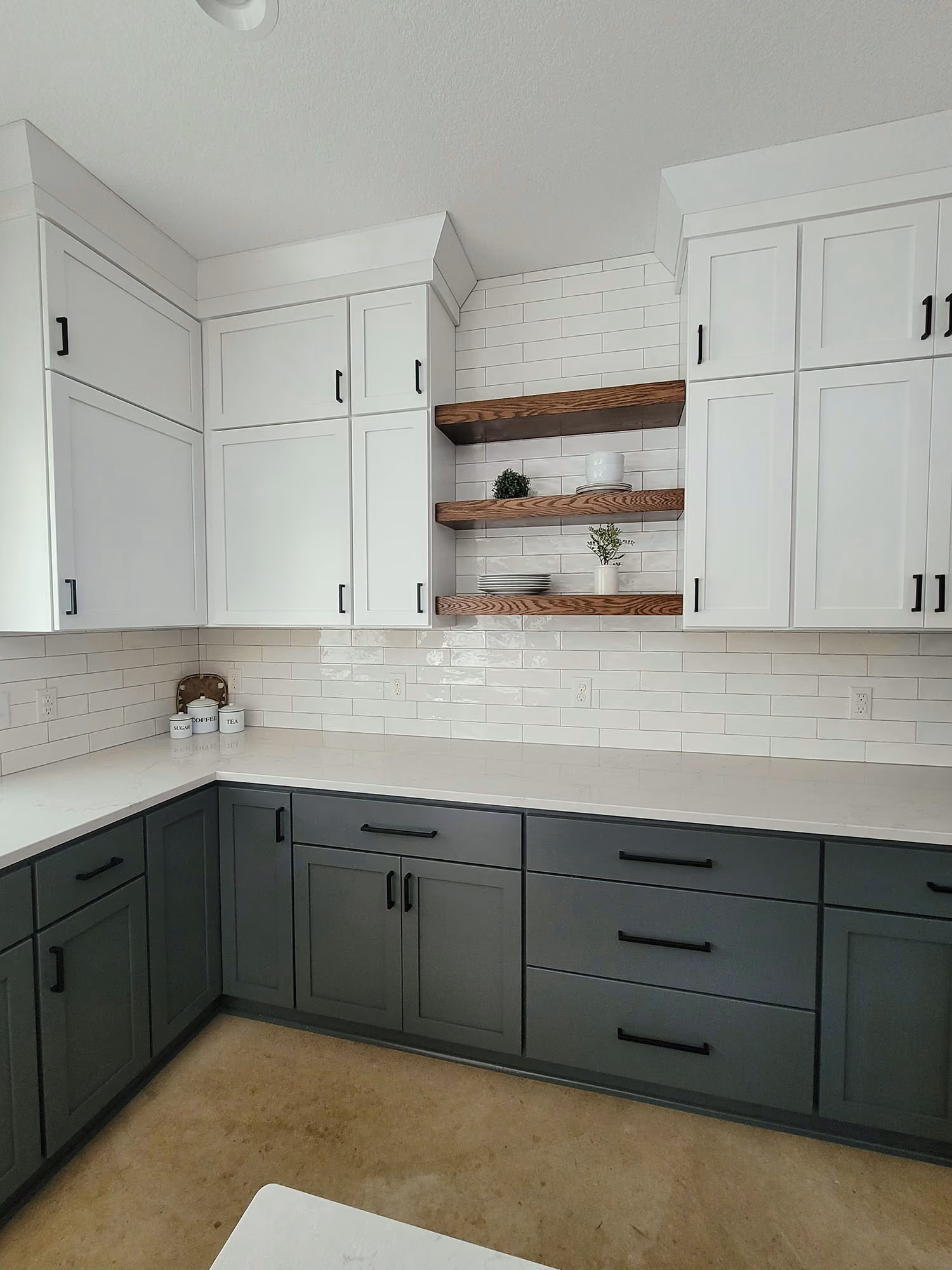 Modern kitchen with gray cabinets and white tile backsplash