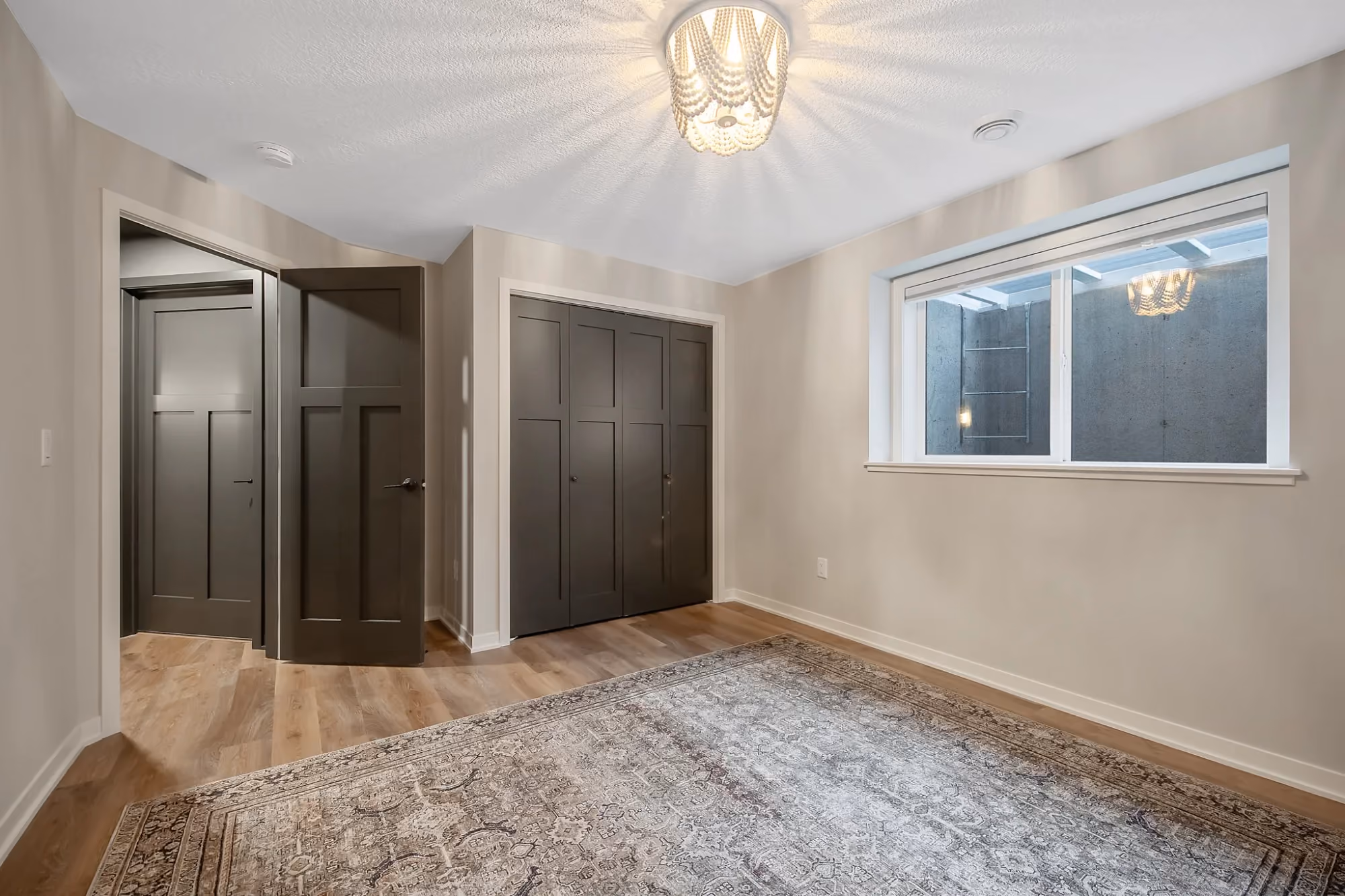 Empty bedroom with gray closet and carpet