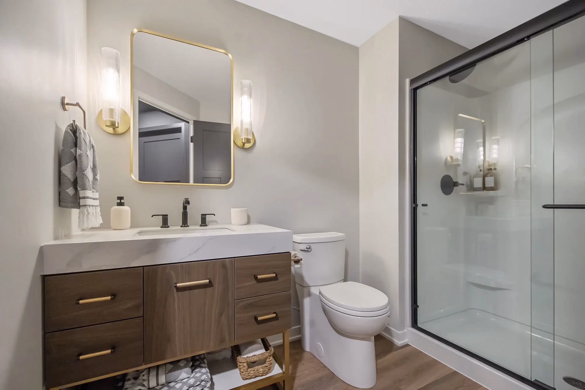 Bathroom vanity with toilet and glass shower