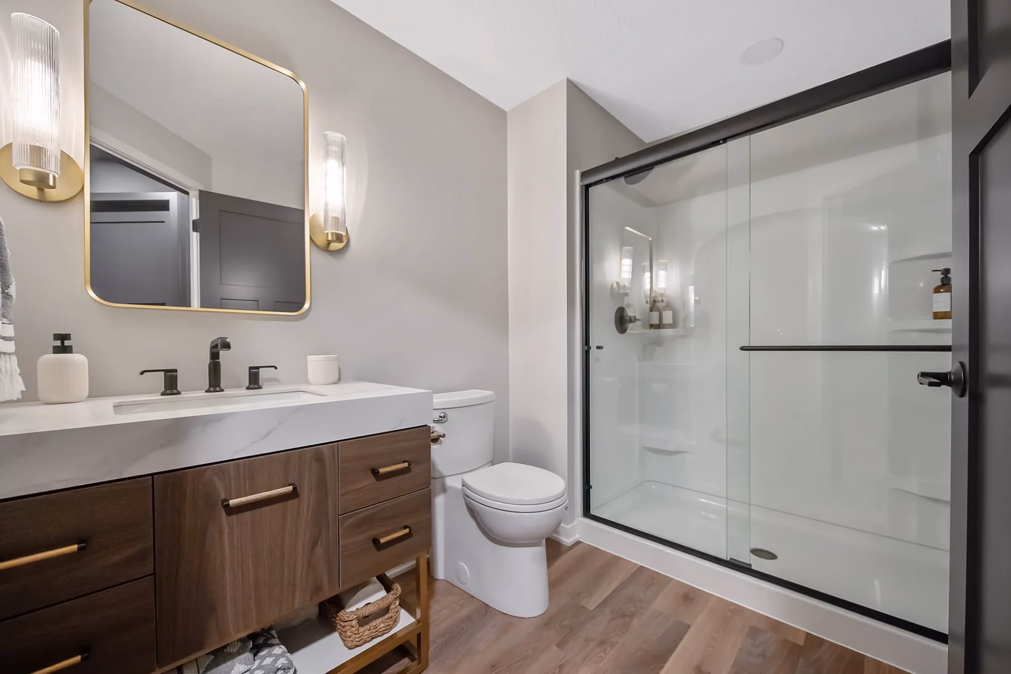 Bathroom vanity with glass shower and toilet