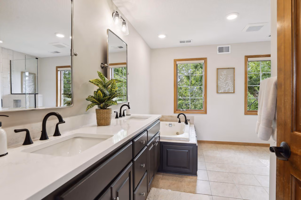 Bright bathroom with double vanity and hallway view
