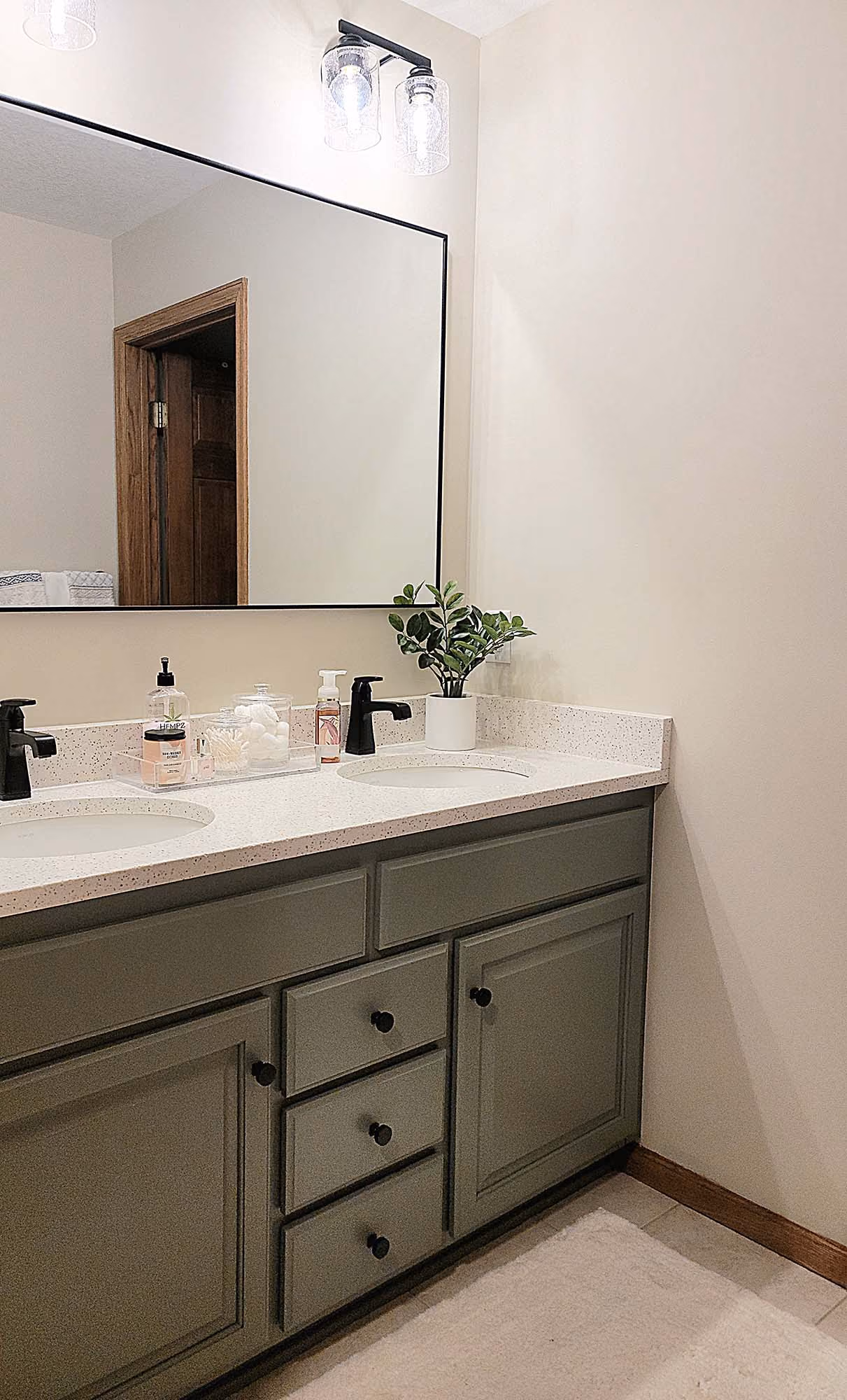 Bathroom vanity next to shower wall