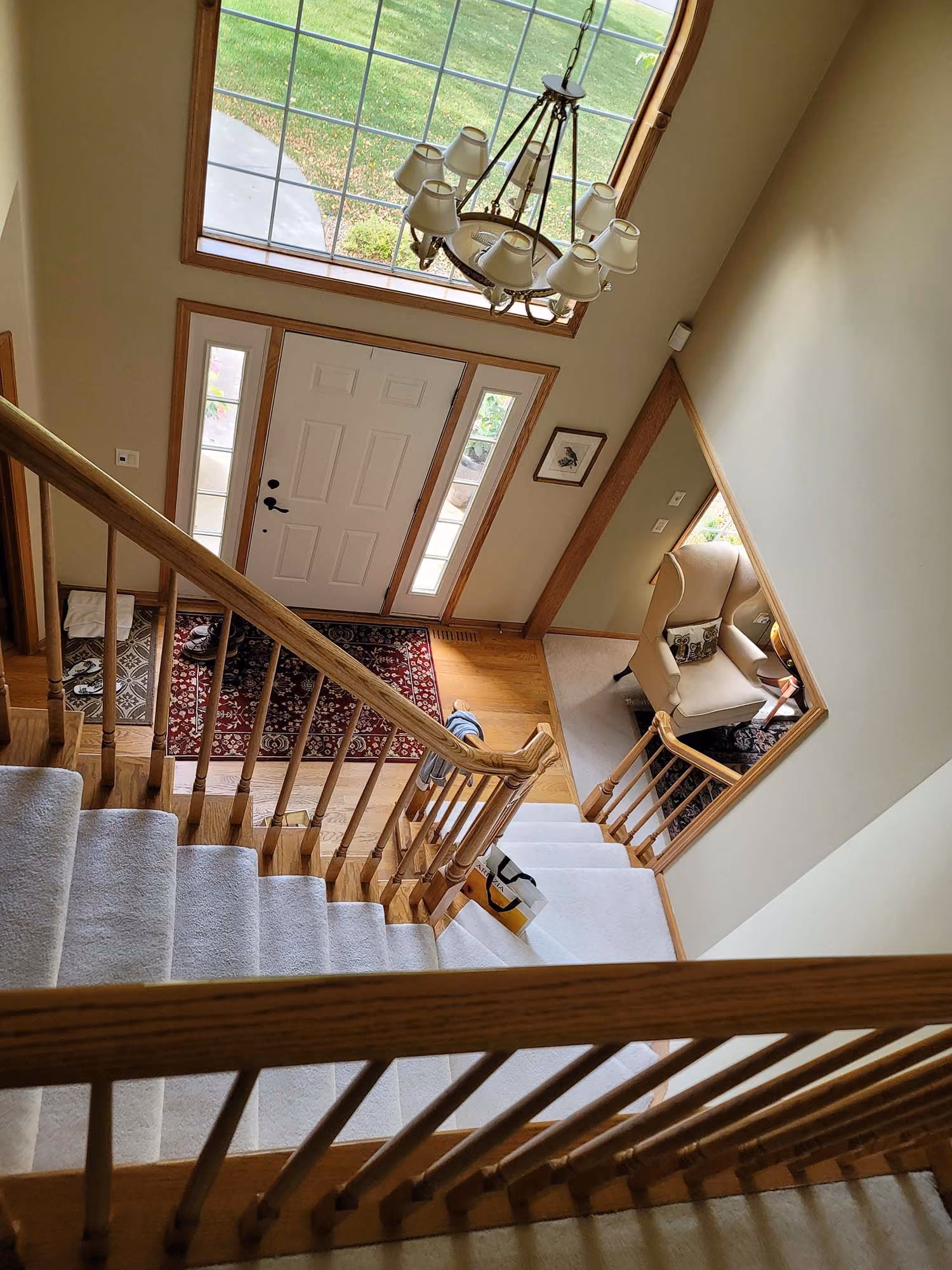 Wood staircase with landing and large windows