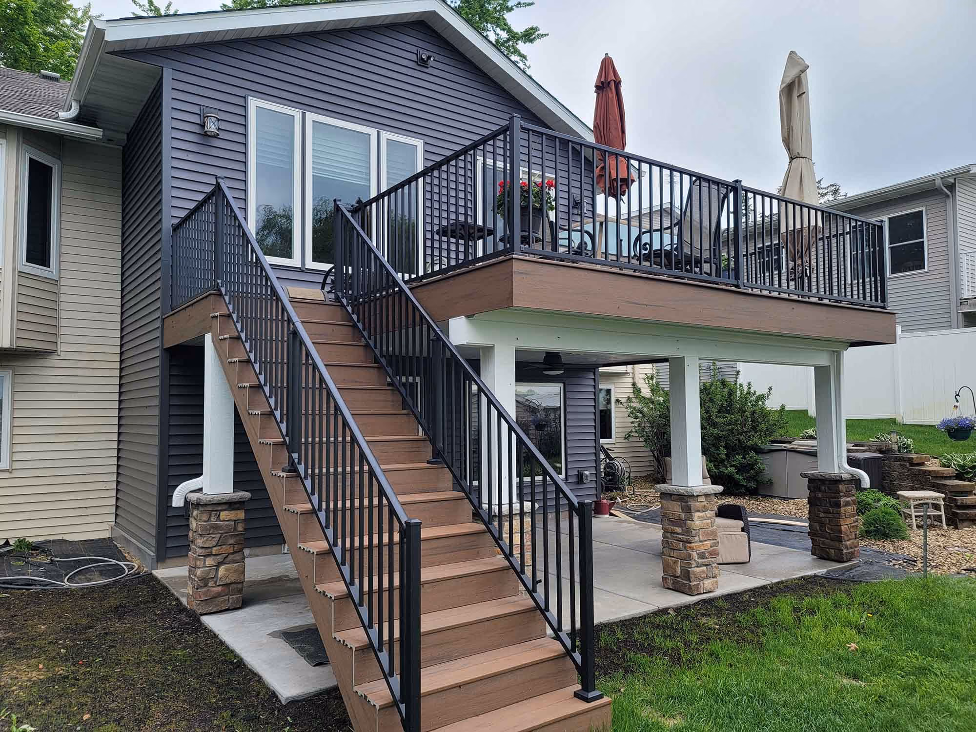 House exterior with raised deck and wooden stairs