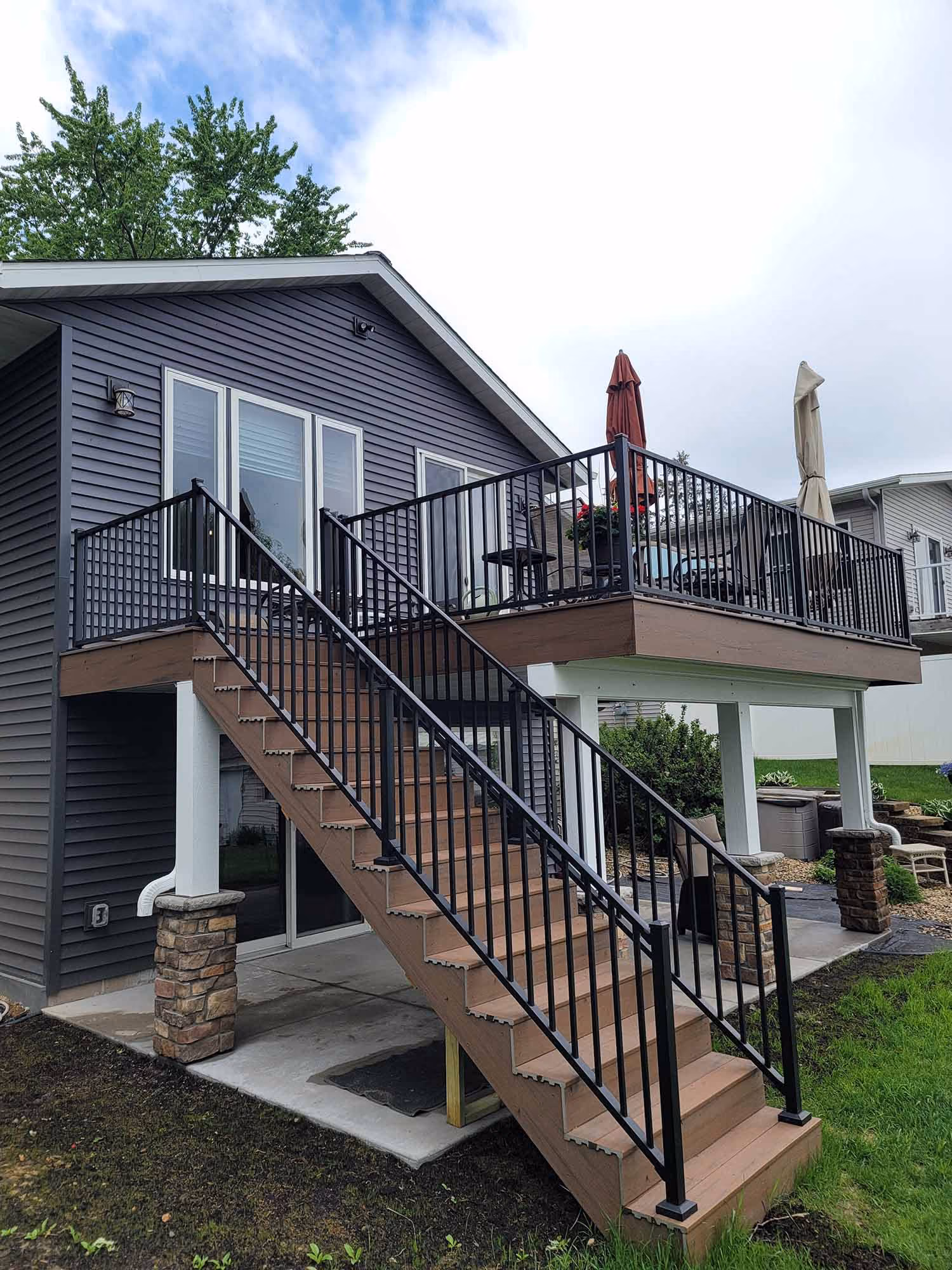 Exterior view of house with staircase to deck