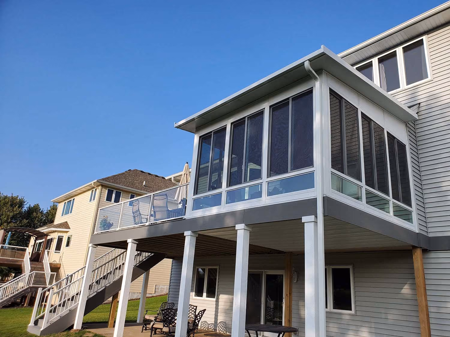 Screened porch addition on stilts under blue sky