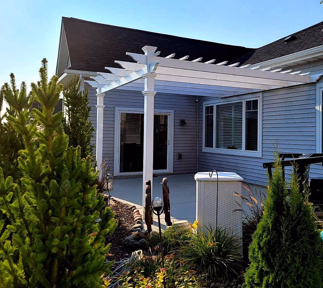 House front with pergola over entry