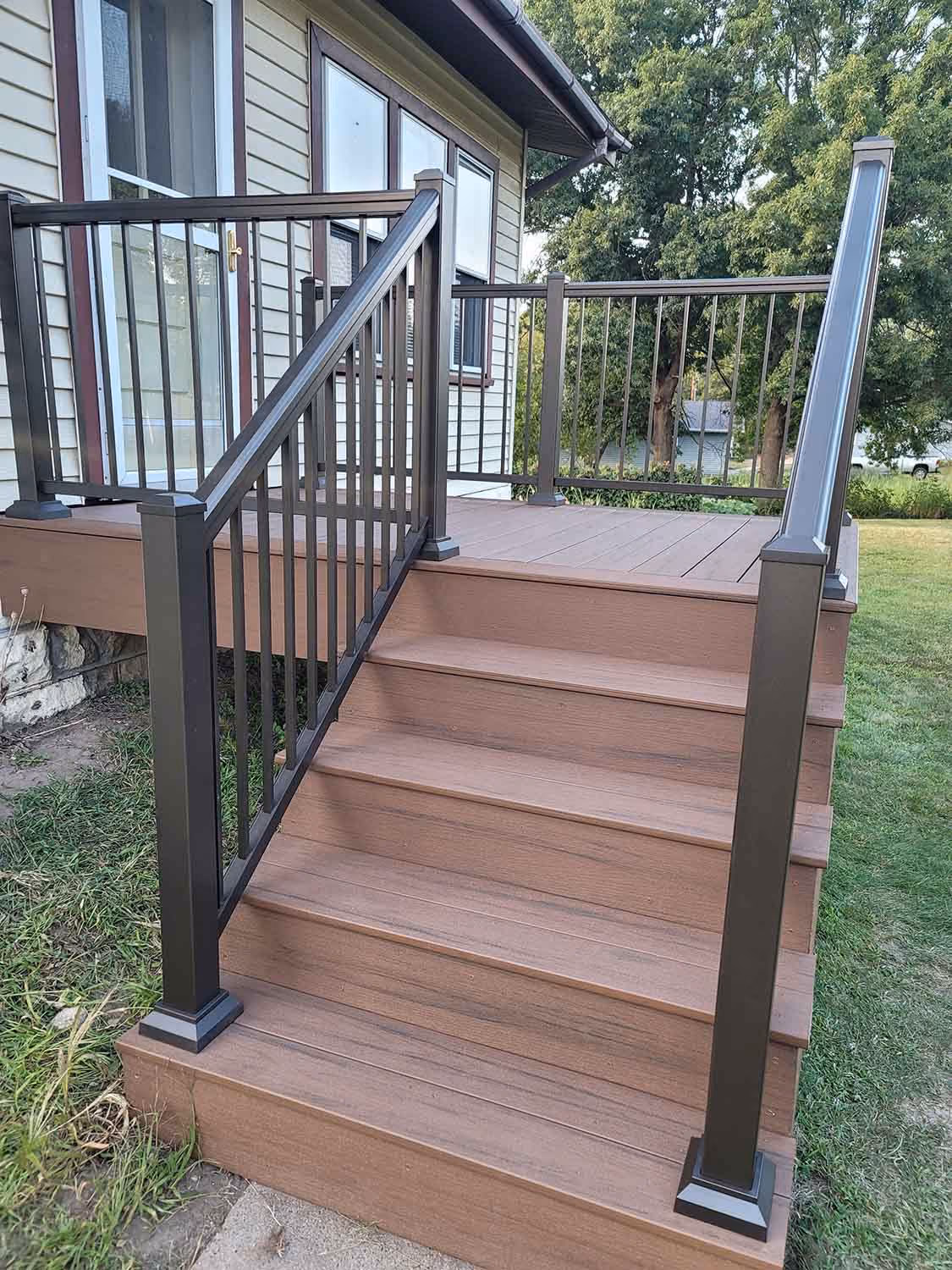 Wooden outdoor steps with black railings