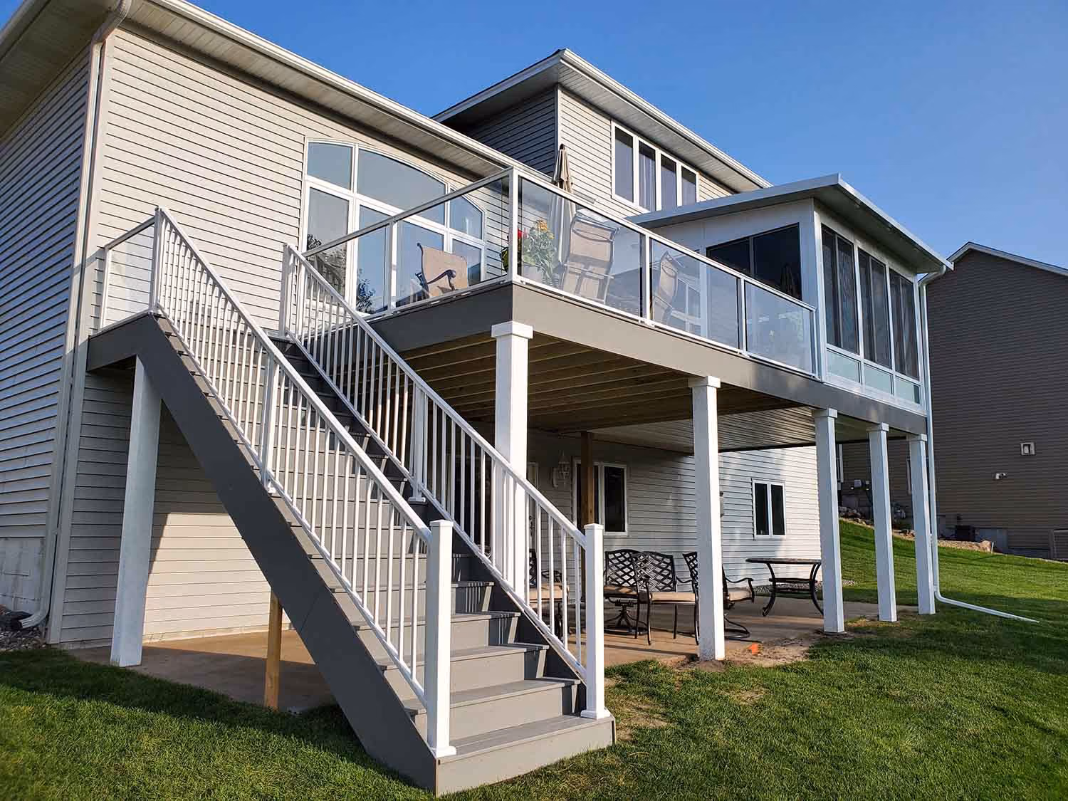Back of house with exterior staircase and upper deck