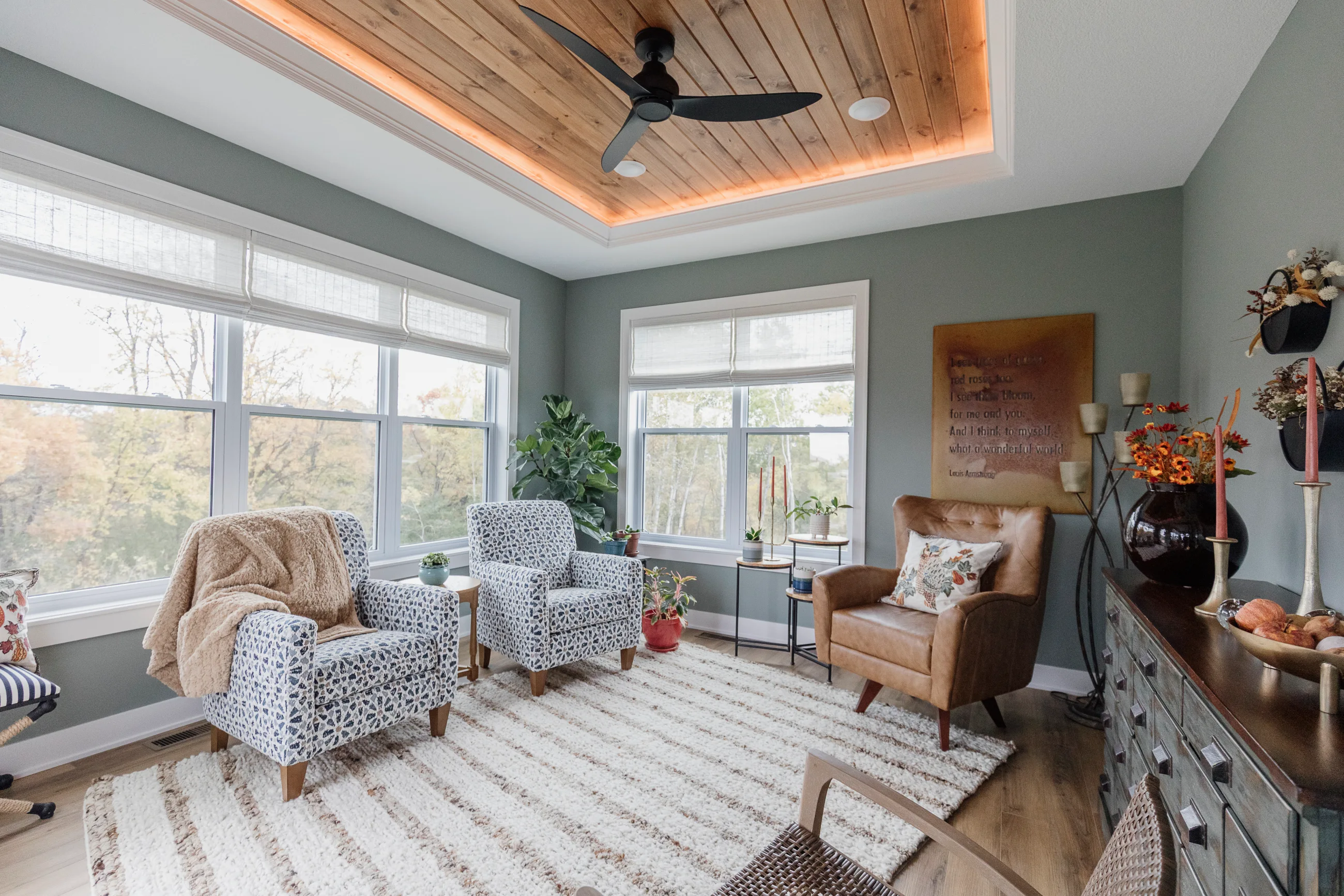 Sunlit living room with patterned rug and large windows