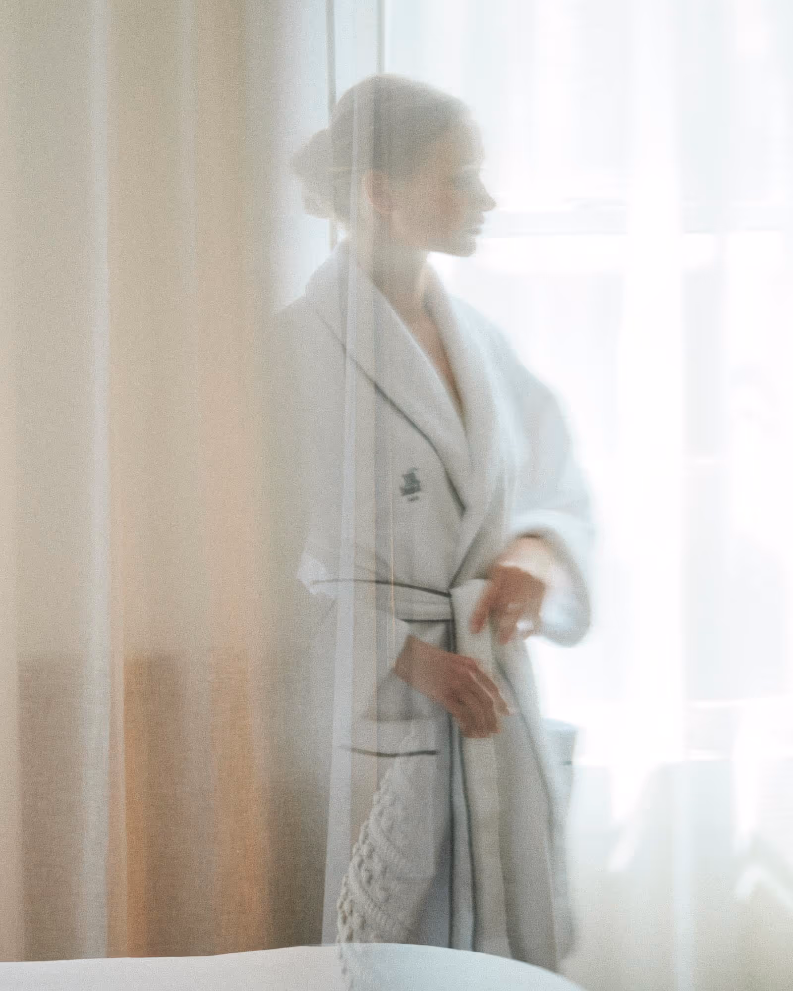 Guest in white robe relaxing at Spa Fjör luxury wellness center, Hotel Viking Newport RI
