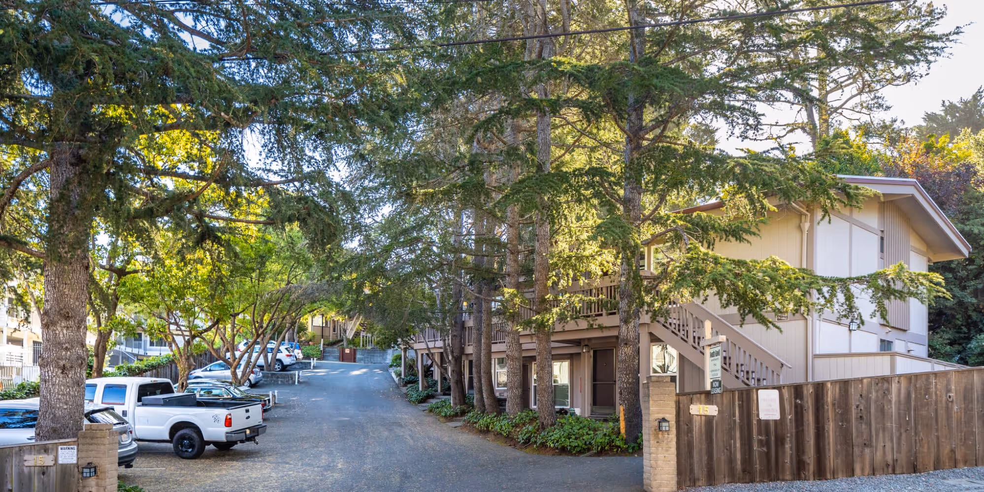 South Knoll exterior surrounded by trees featuring view of parking lot with cars