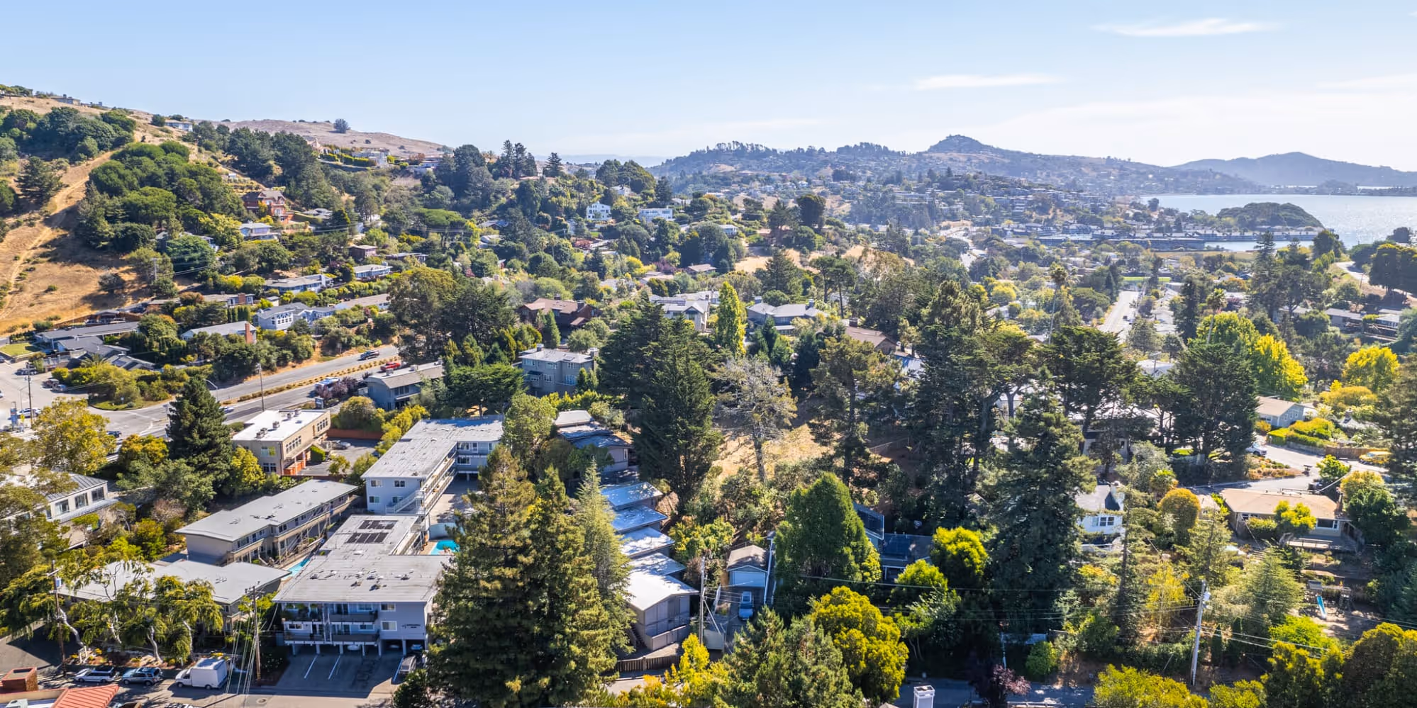Drone shot of South Knoll exterior and surrounding area skyline with mountainous landscape in distance
