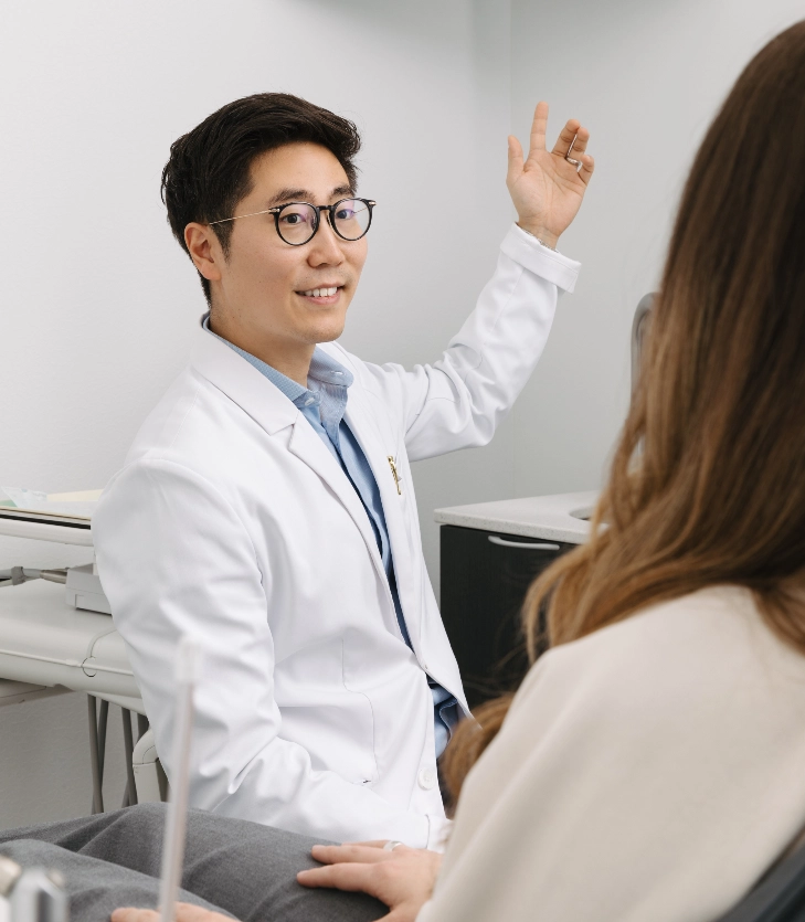 Dr. Chris Kim reviewing patient records with a patient at Livewell Dental