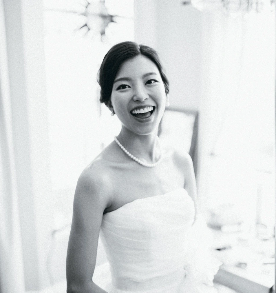 Bride smiling in wedding gown after smile makeover planning