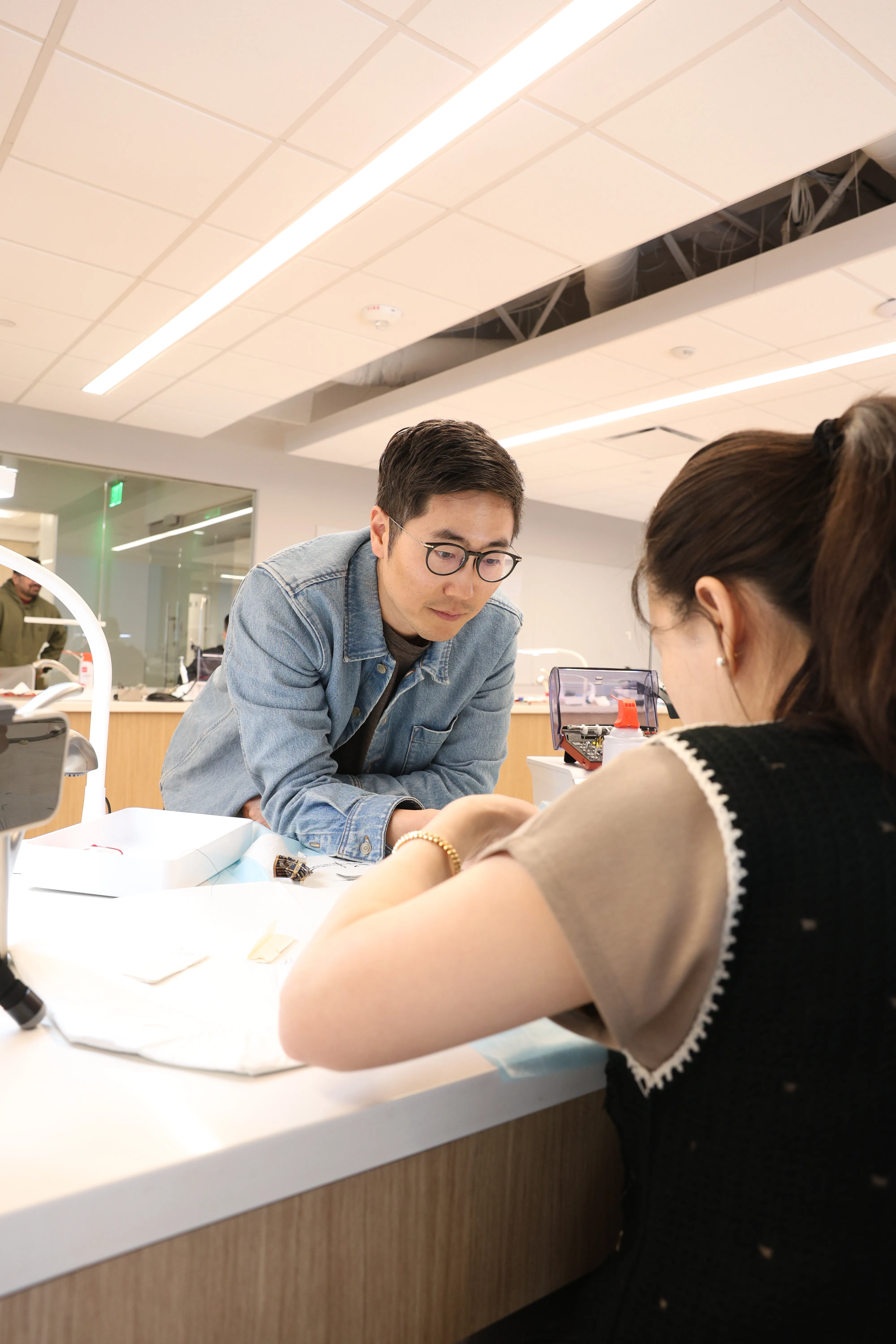 Dr. Chris Kim instructing dental professionals at a hands-on workshop