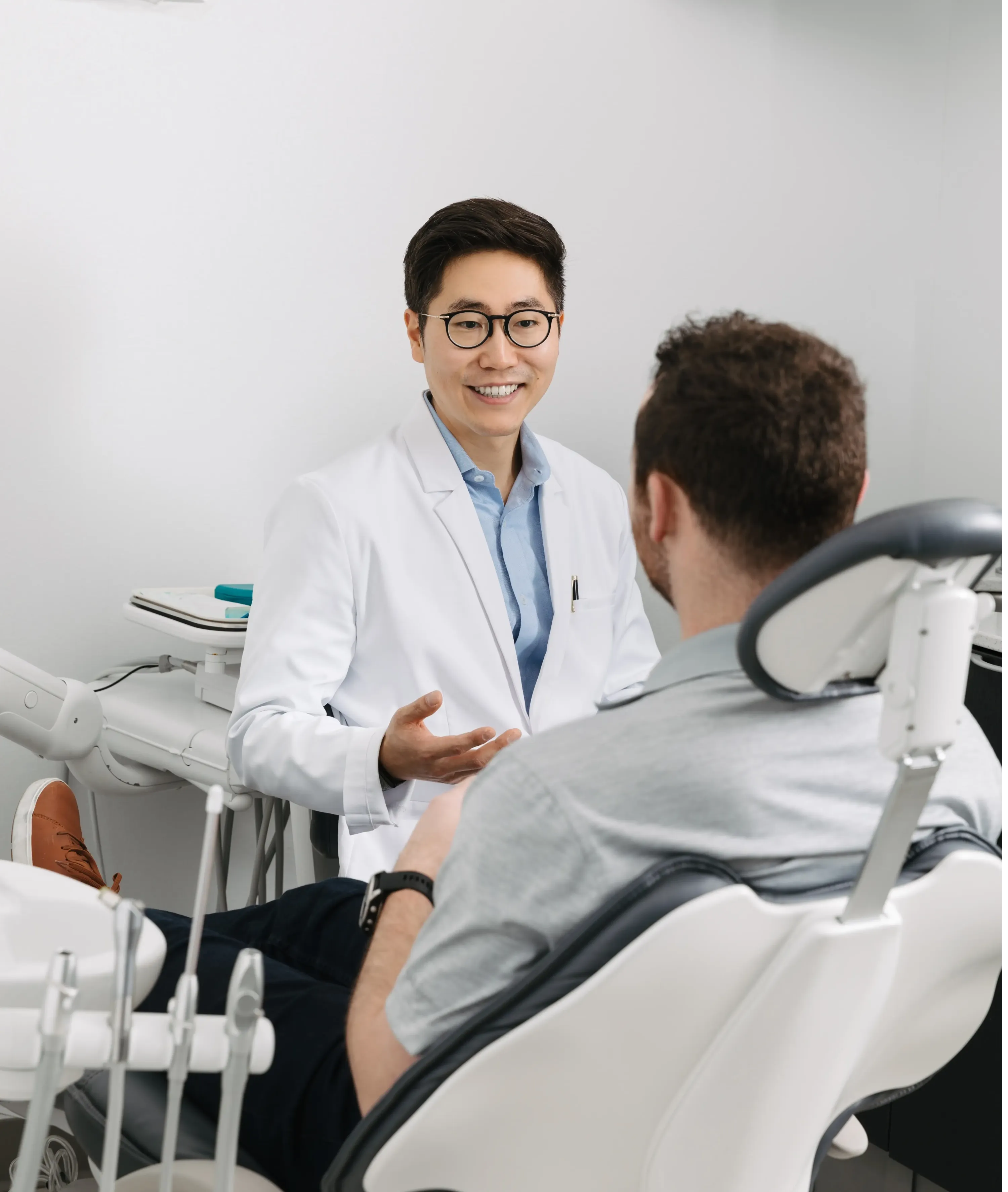 "Dr. Chris Kim consulting with a patient at Livewell Dental, Fairfax Station, VA