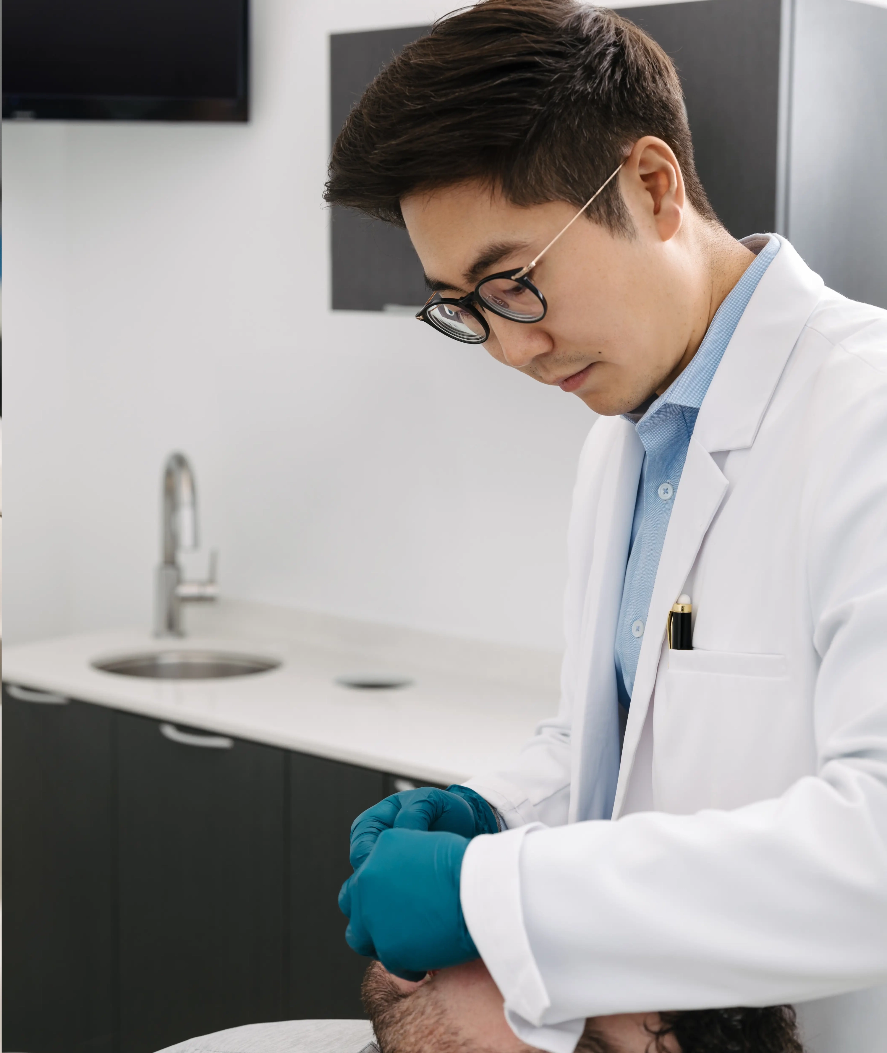 Dr. Chris Kim reviewing a patient case presentation at Livewell Dental