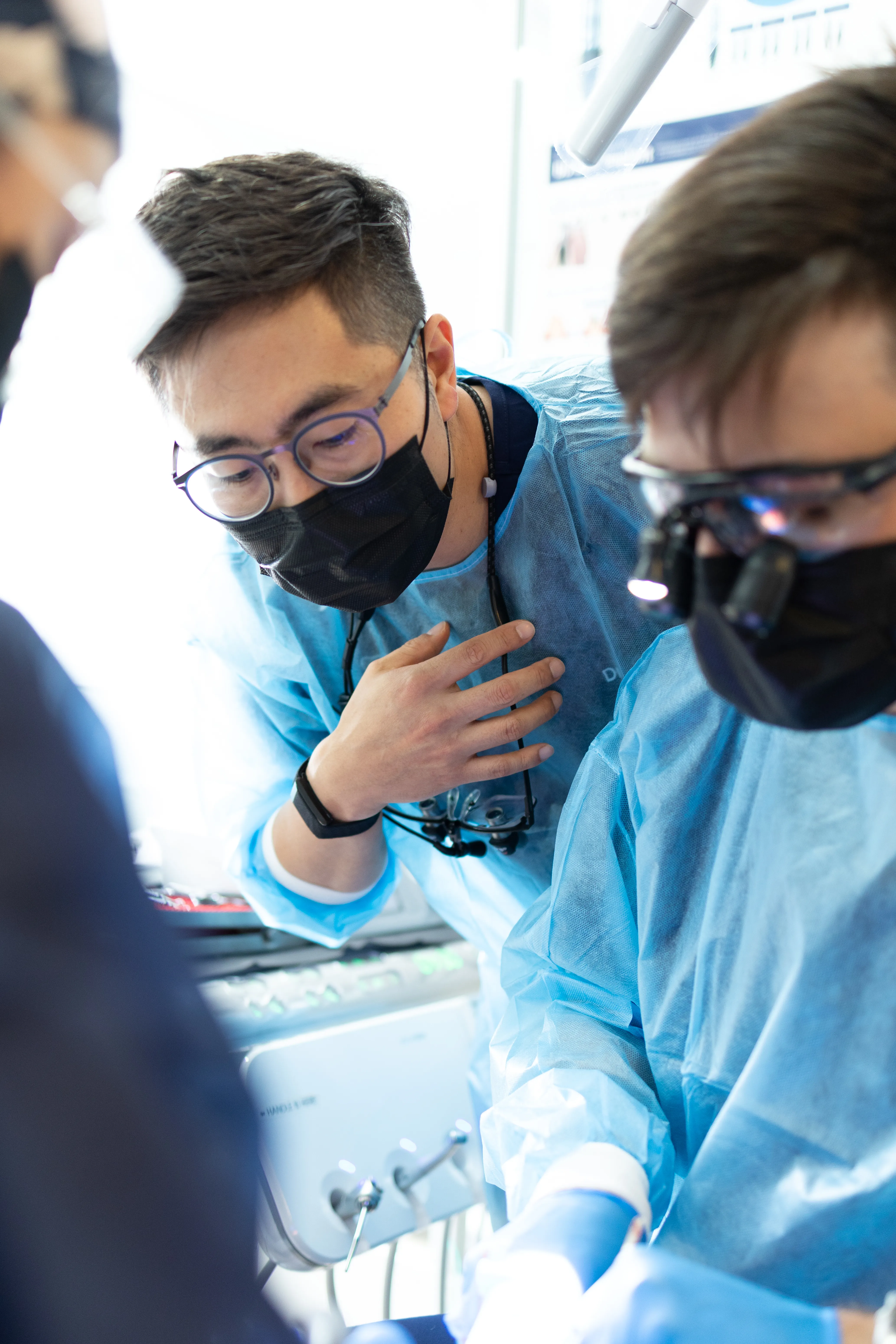 Dr. Chris Kim instructing dental professionals at a hands-on training session