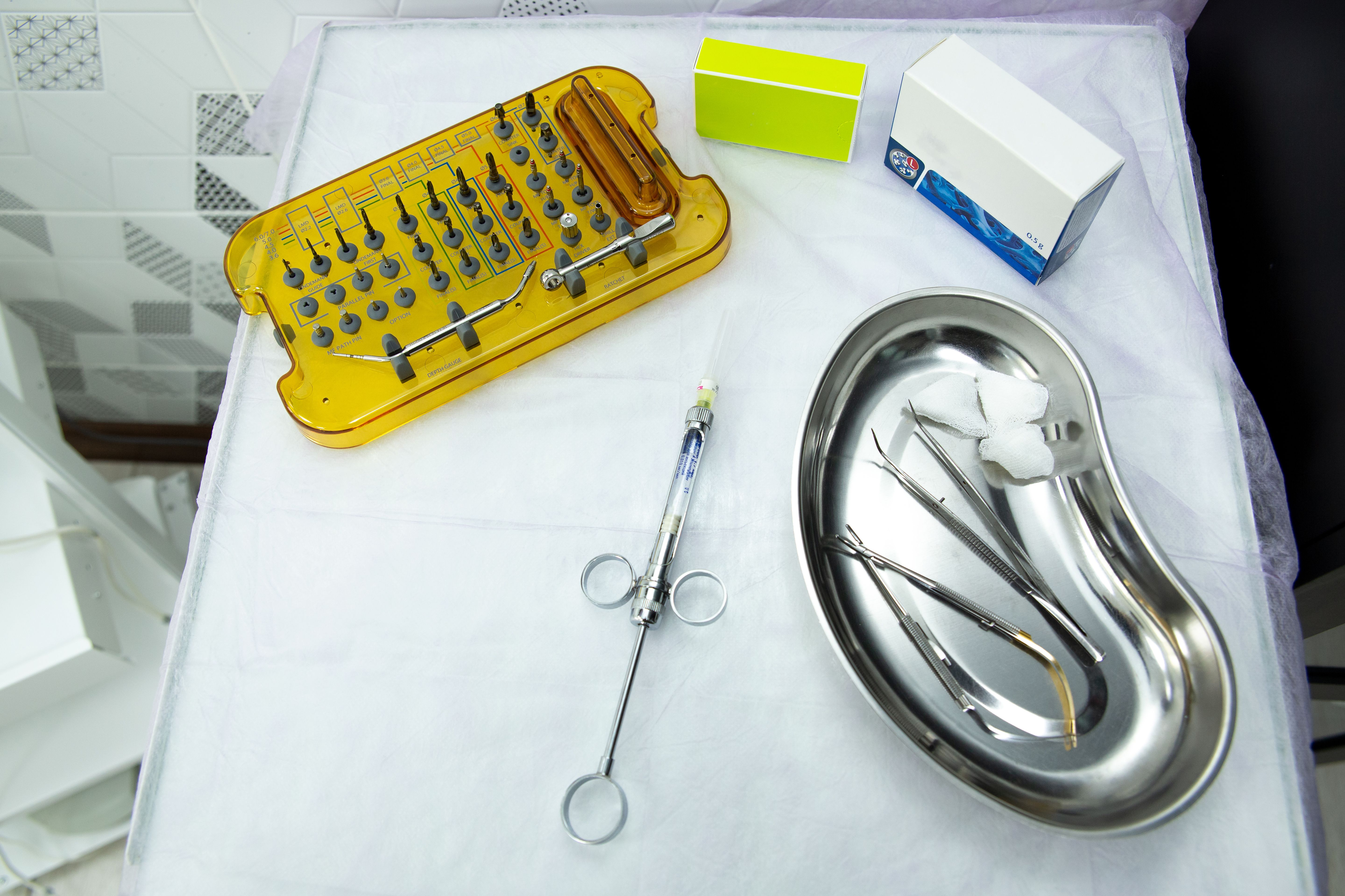 Flat lay of cosmetic dentistry tools and a veneer model